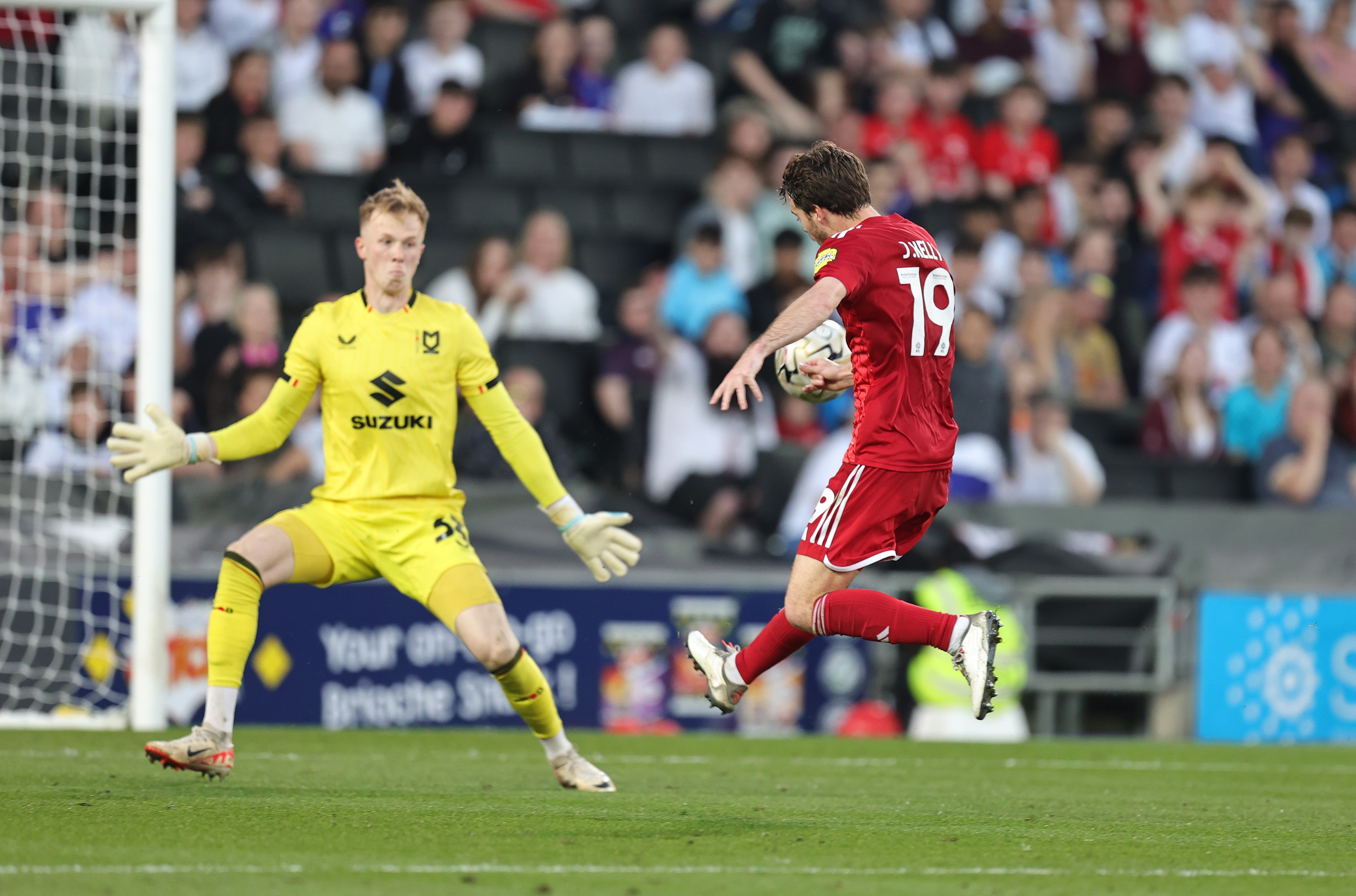 Jeremy Kelly of Crawley Town lifts the ball over Filip Marschall