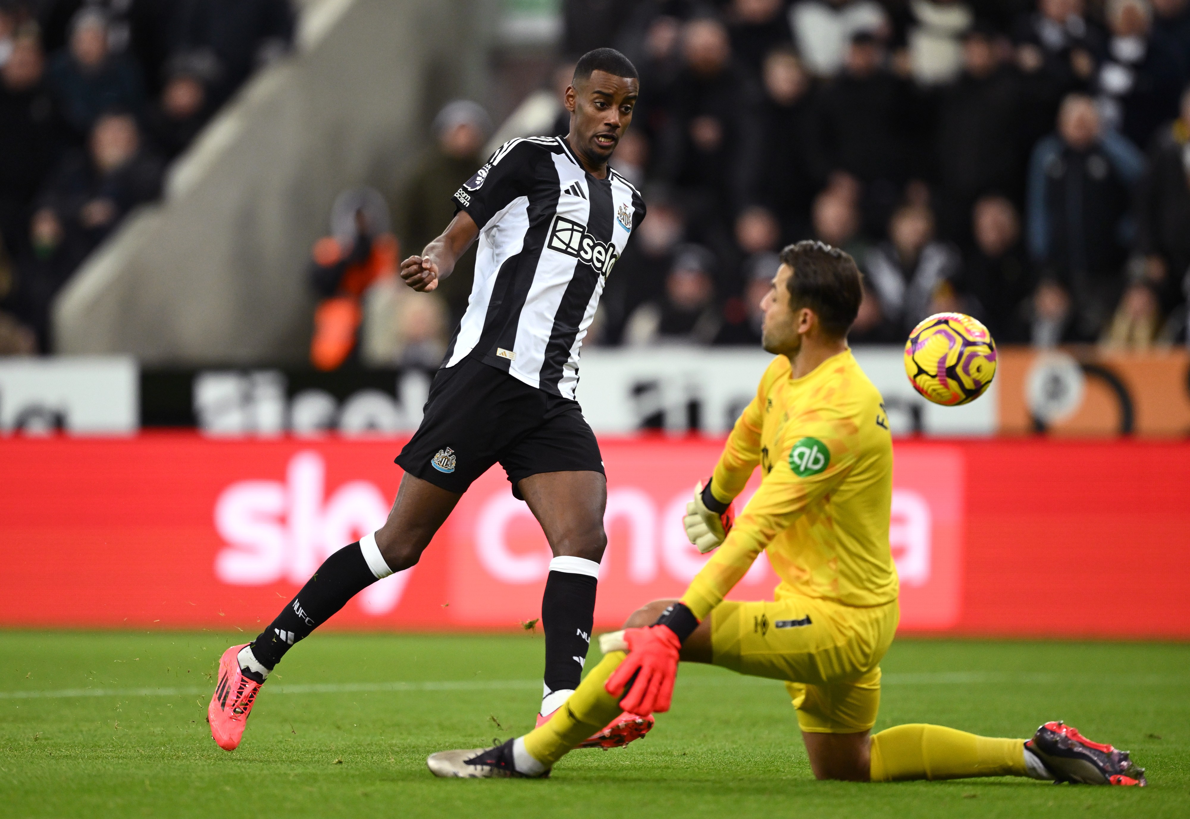 Alexander Isak of Newcastle scores a goal past Lukasz Fabianski