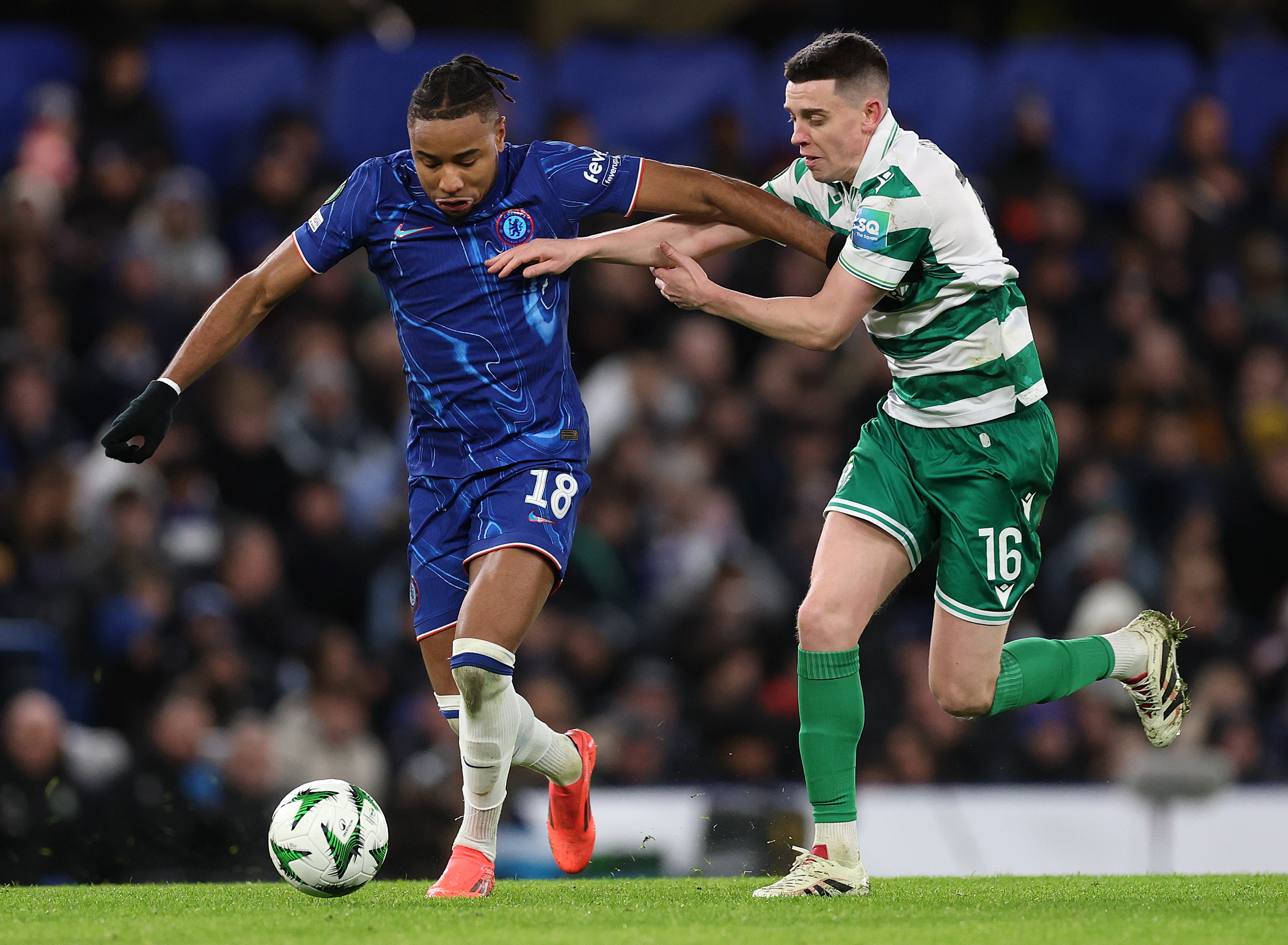 Christopher Nkunku holds off Shamrock Rovers star during Europa Conference League clash.