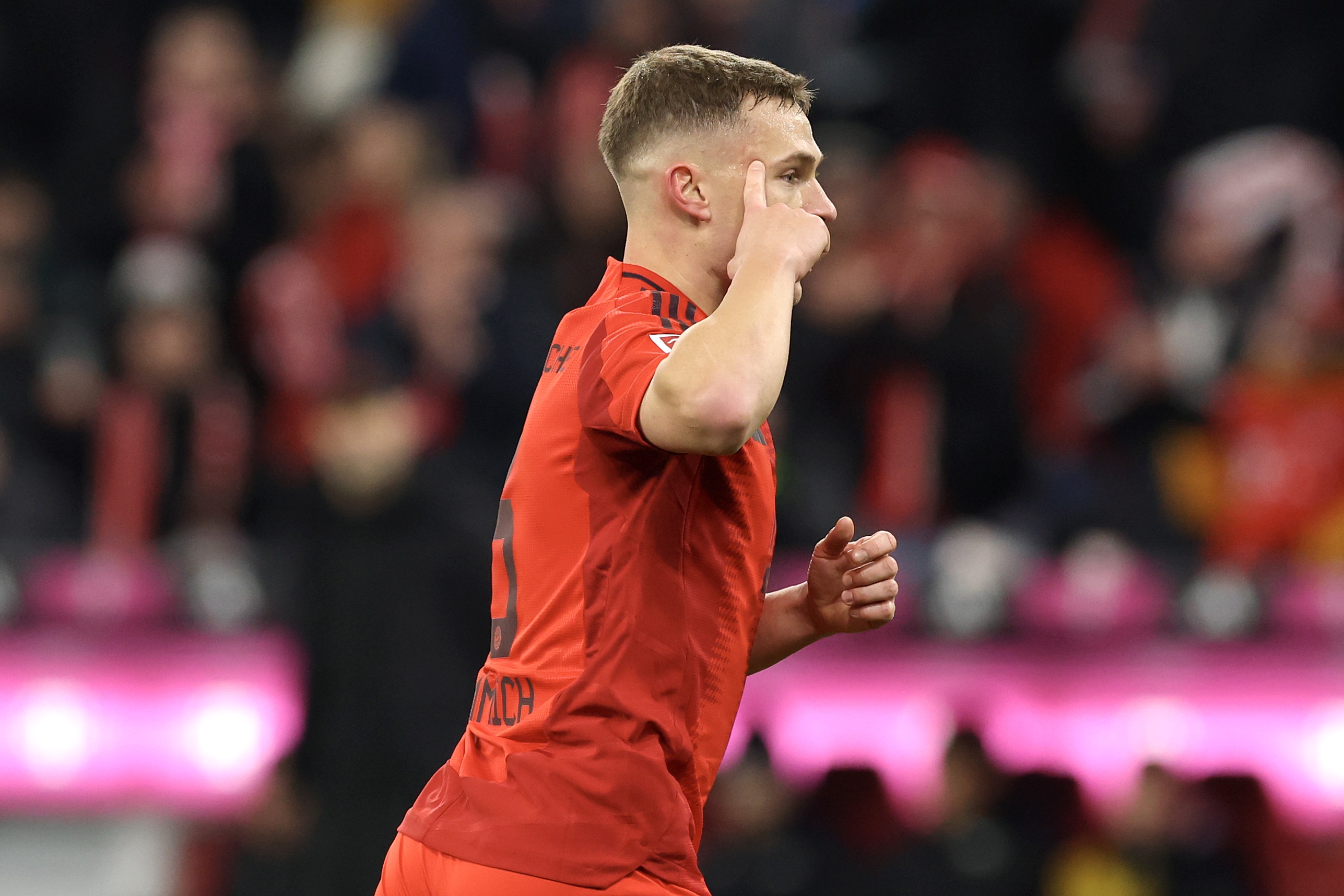 Joshua Kimmich celebrates scoring the winning goal for Bayern at the Allianz Arena.