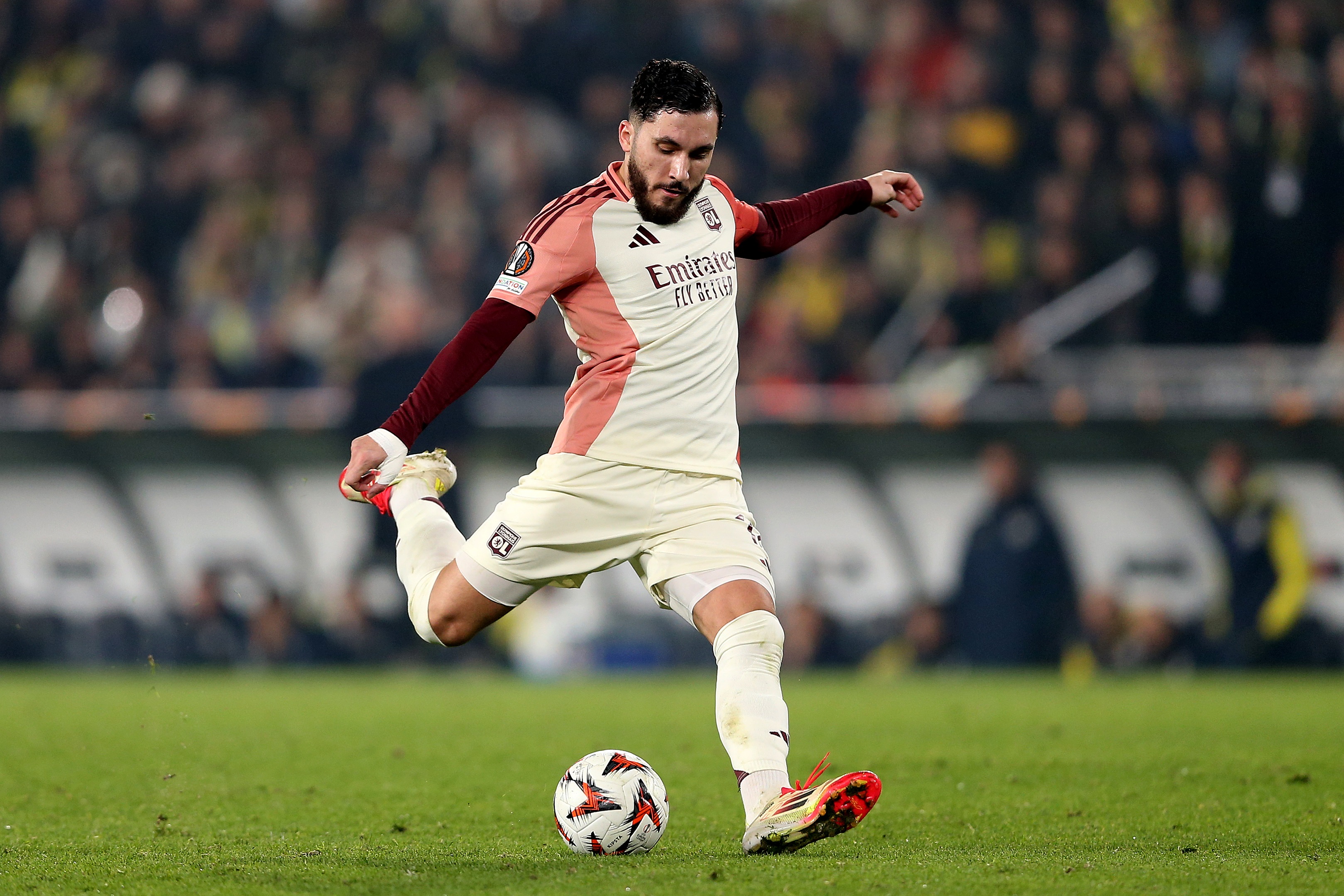 Liverpool Target Rayan Cherki fires the ball for Lyon.