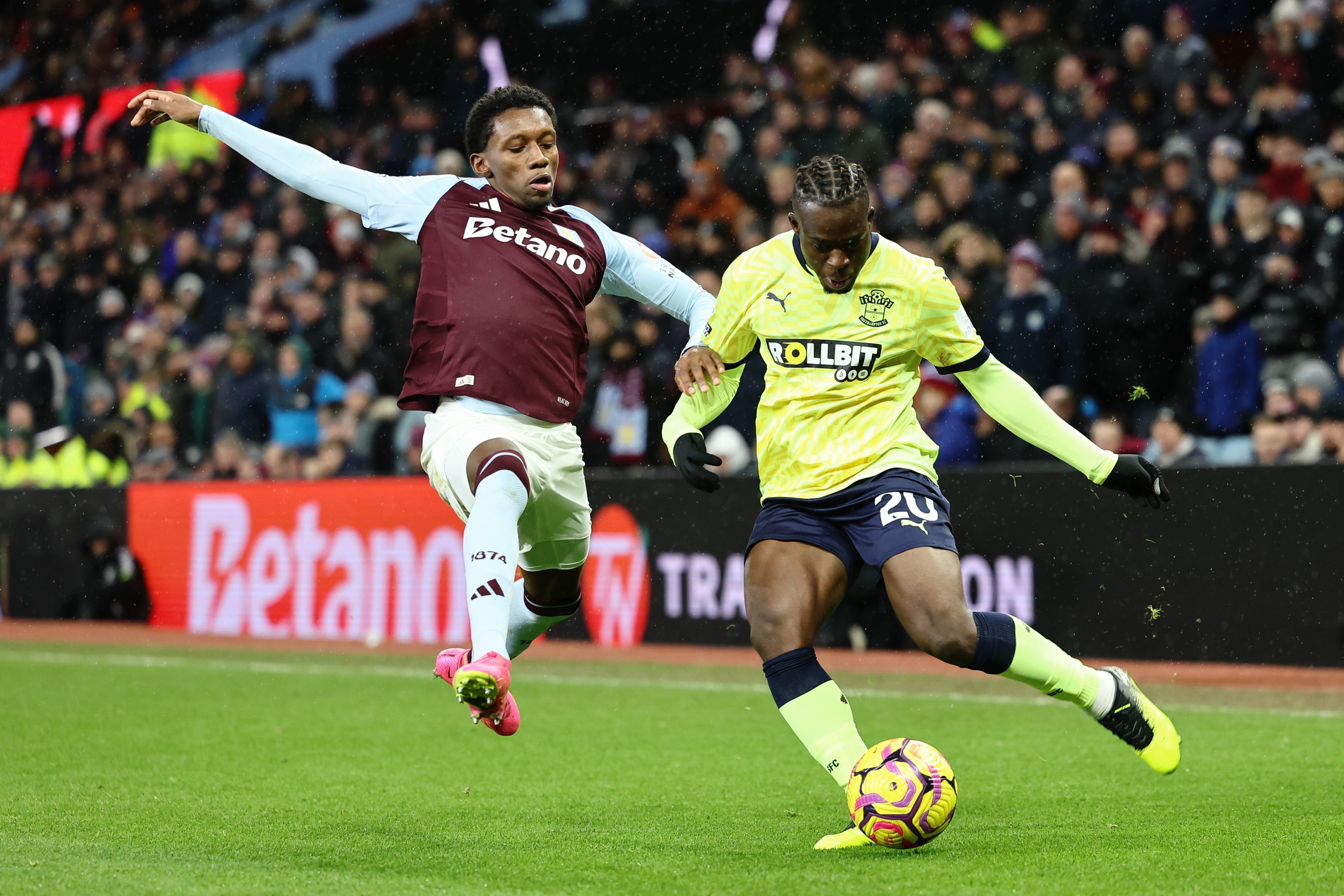 Kamaldeen Sulemana of Southampton crosses the ball under pressure from Jaden Philogene of Aston Villa.