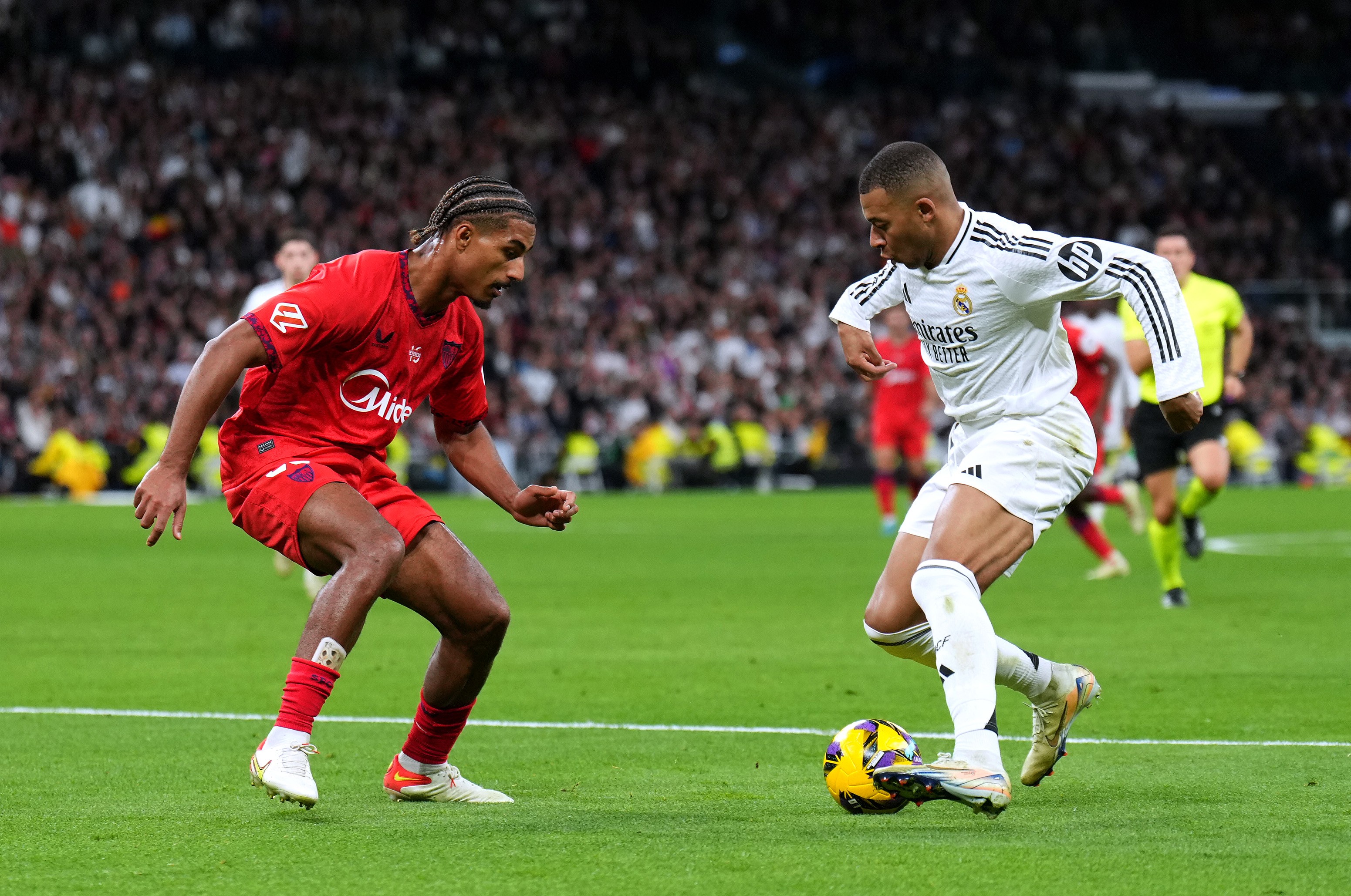 Kylian Mbappe of Real Madrid attempts to take on Loic Bade of Sevilla FC.