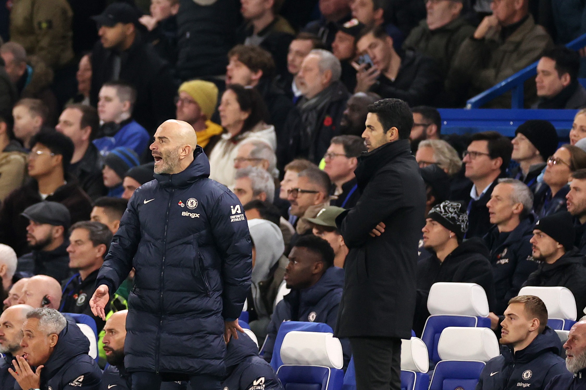 Enzo Maresca, manager of Chelsea, reacts with Mikel Arteta, manager of Arsenal.