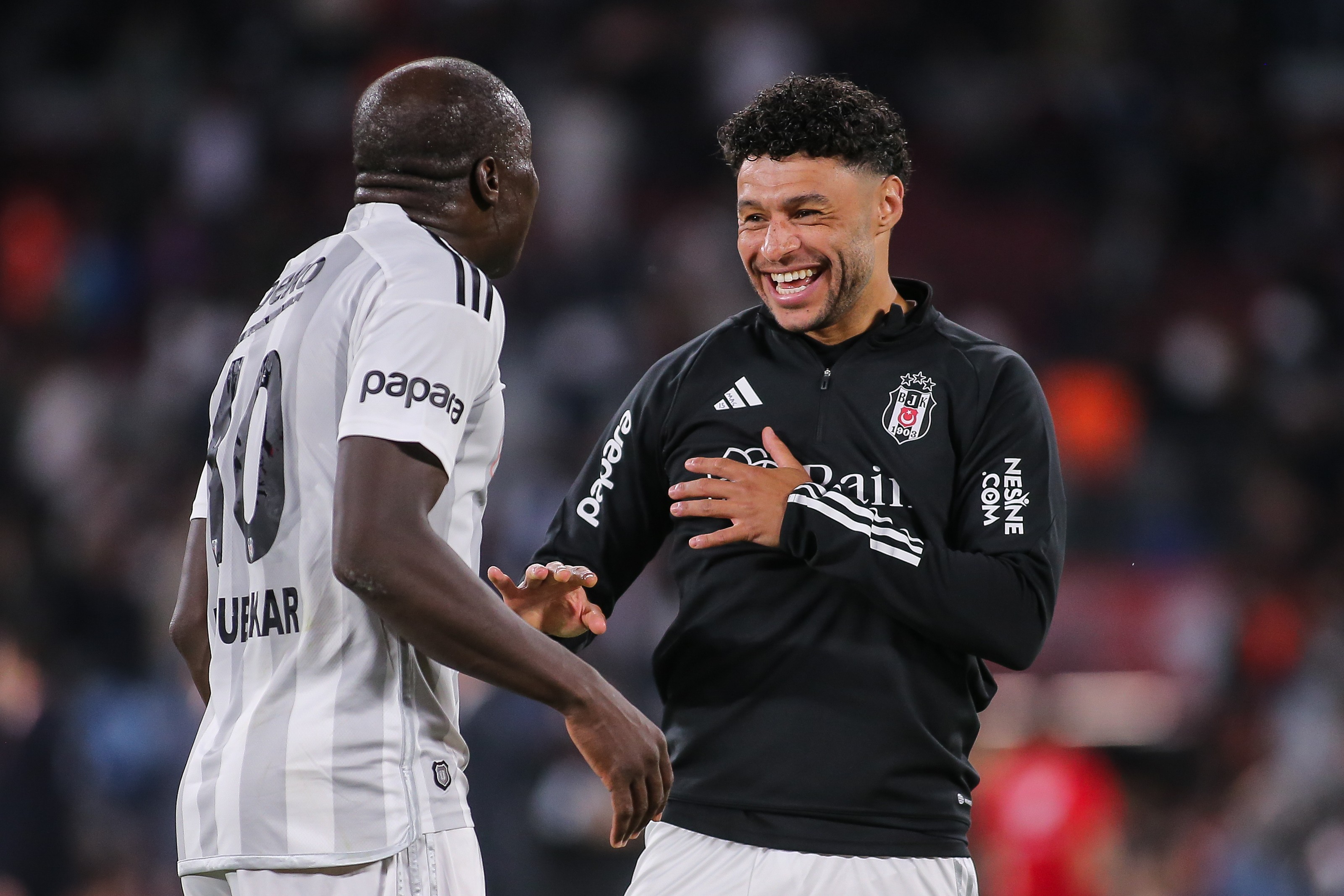 Vincent Aboubakar and Alex Chamberlain of Besiktas celebrate victory
