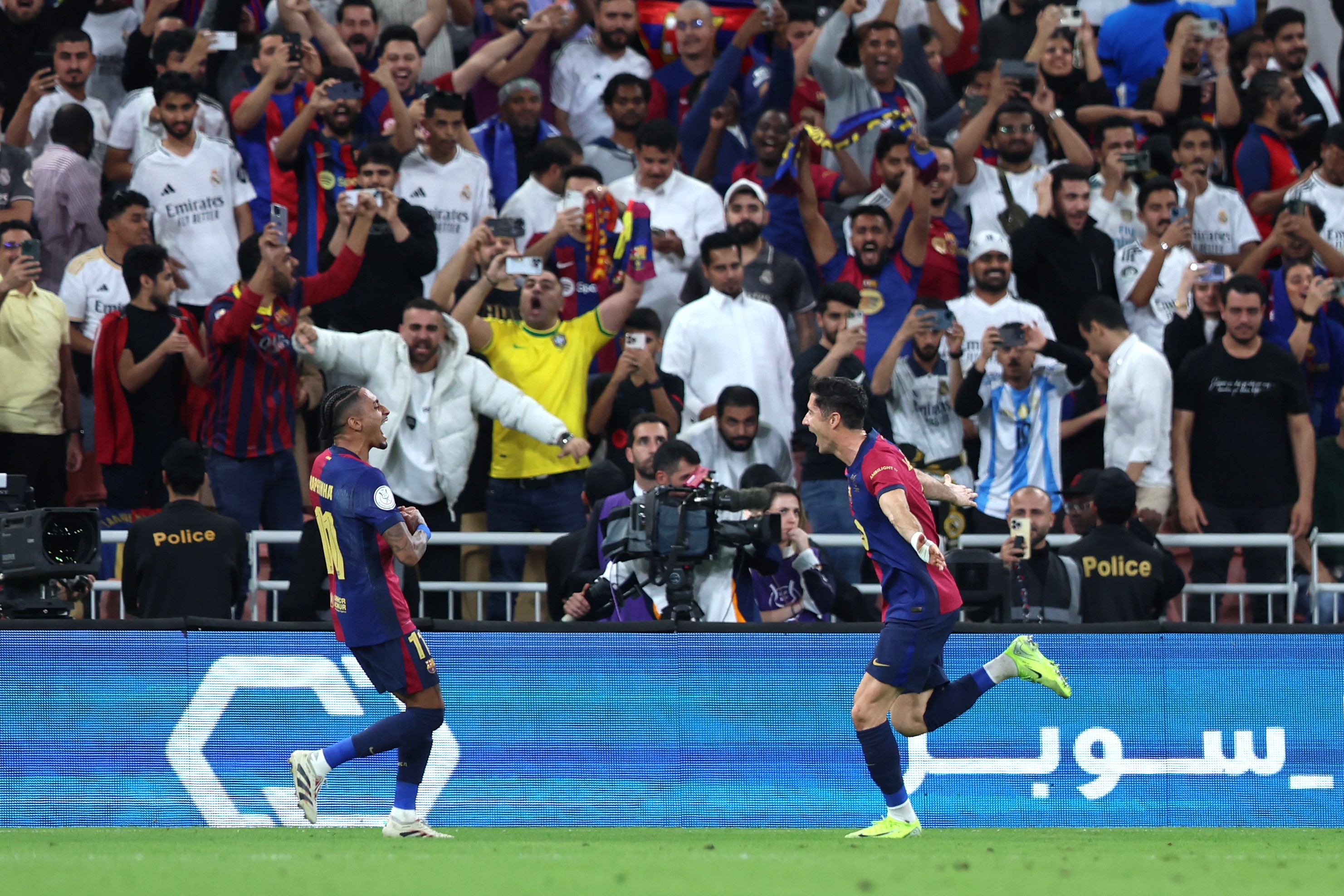 FC Barcelona's Robert Lewandowski celebrates his team's second goal with his teammate Raphinha