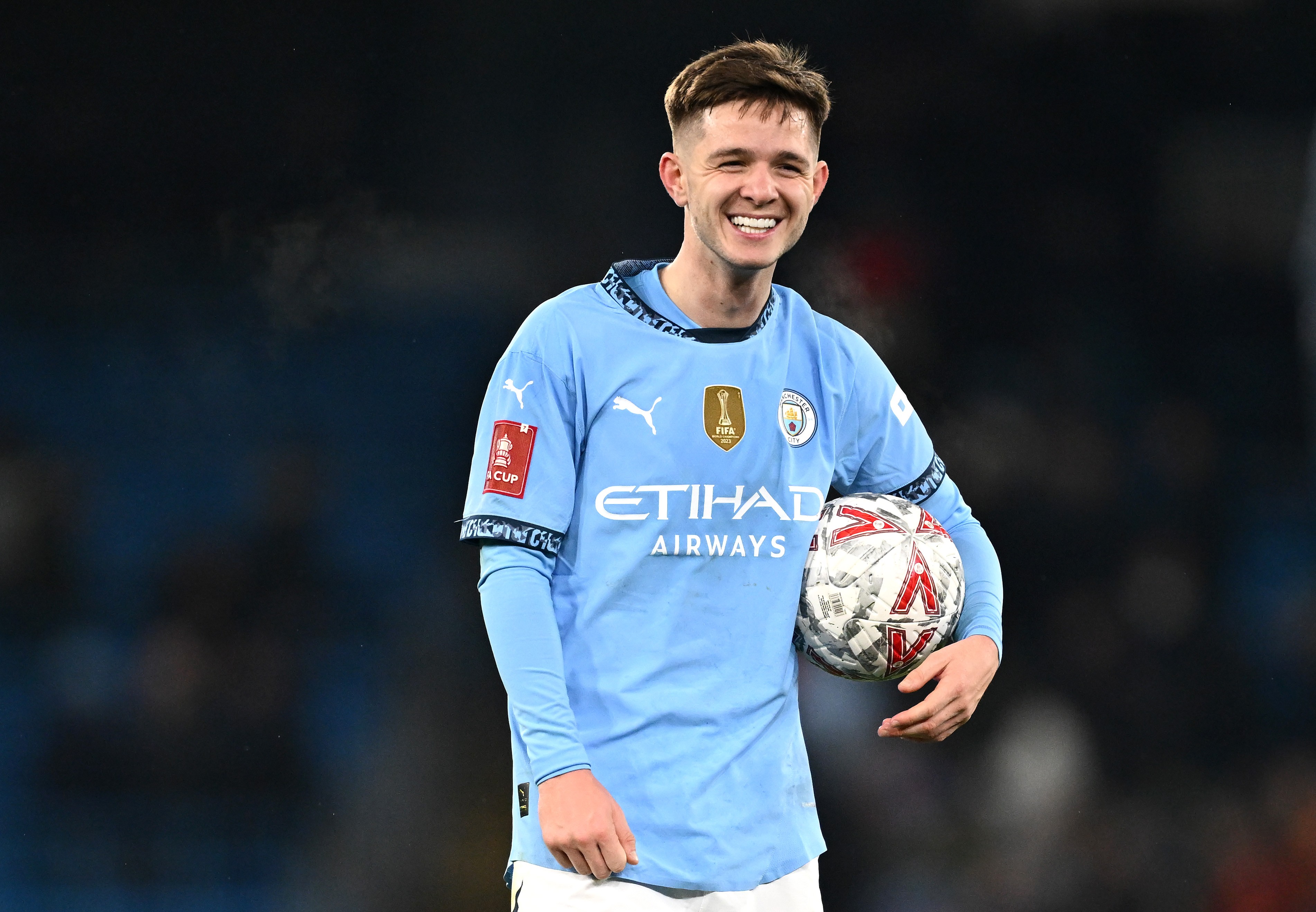 James McAtee of Manchester City holding the match ball