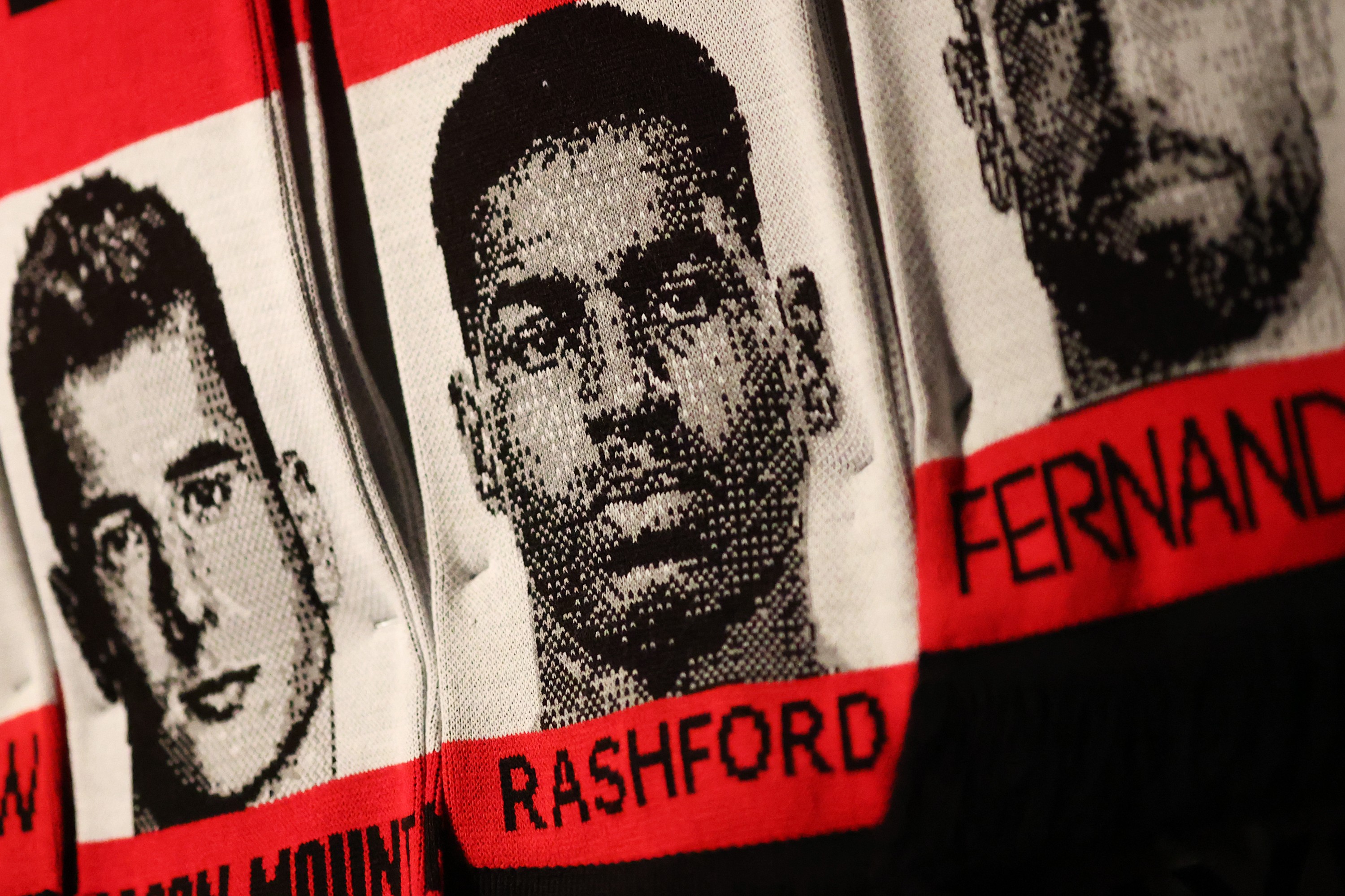 General view of a scarf on display with the headshots of Manchester United players Luke Shaw, Mason Mount, Marcus Rashford and Bruno Fernandes.