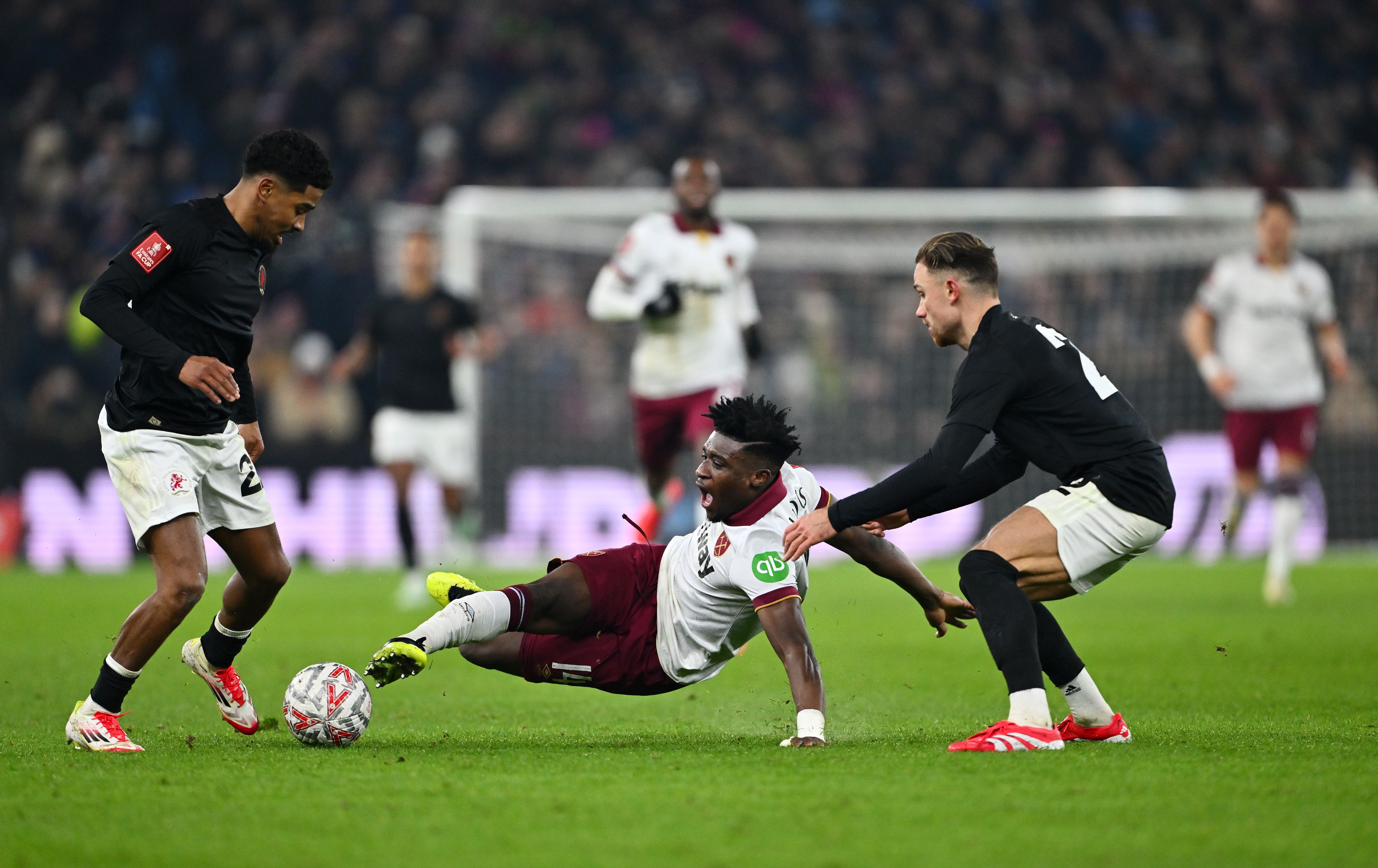 Mo Kudus of West Ham United is challenged by Ian Maatsen and Matty Cash