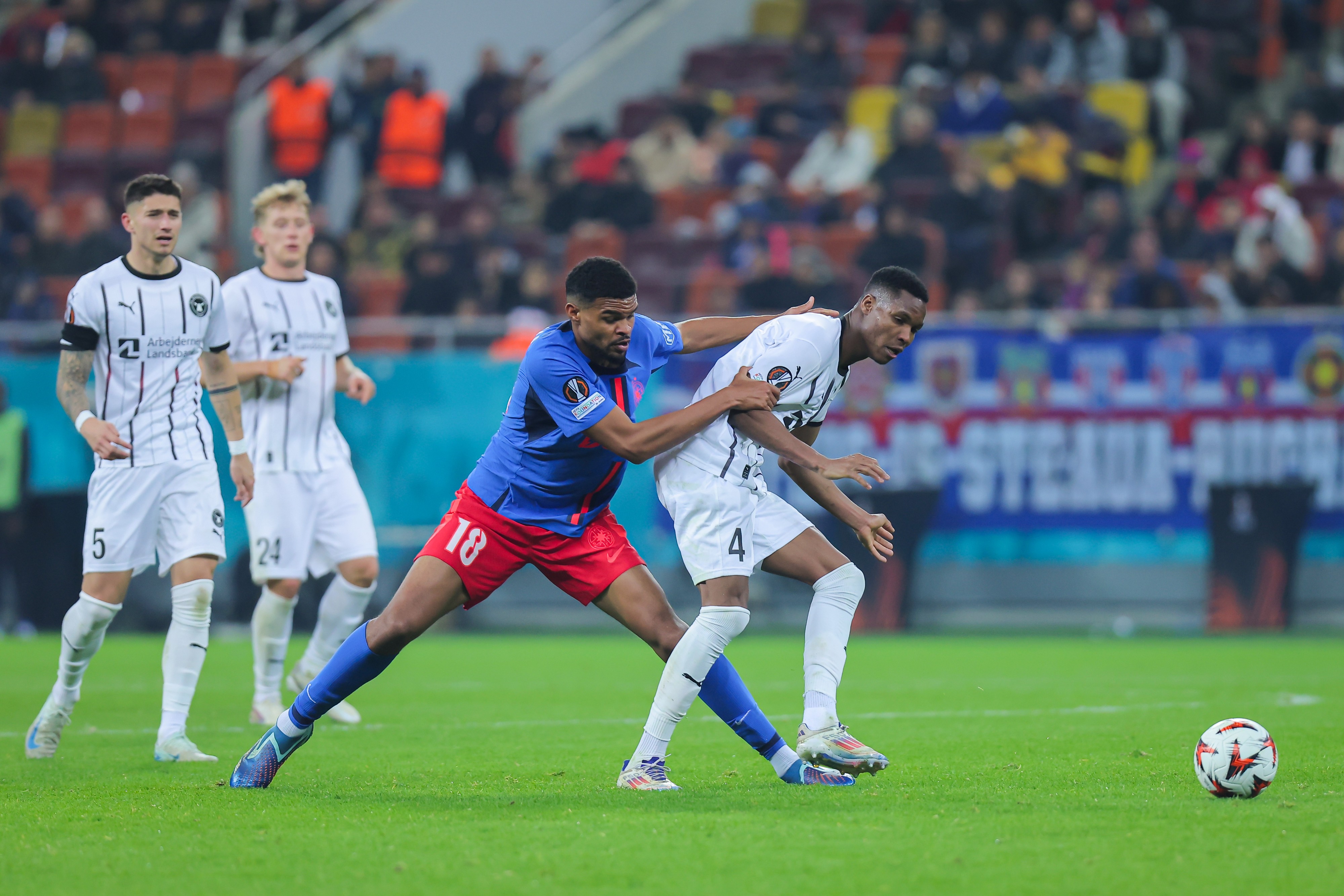 Malcom Edjouma (L) of FCSB fights for the ball with Ousmane Diao (R) of FC Midtjylland