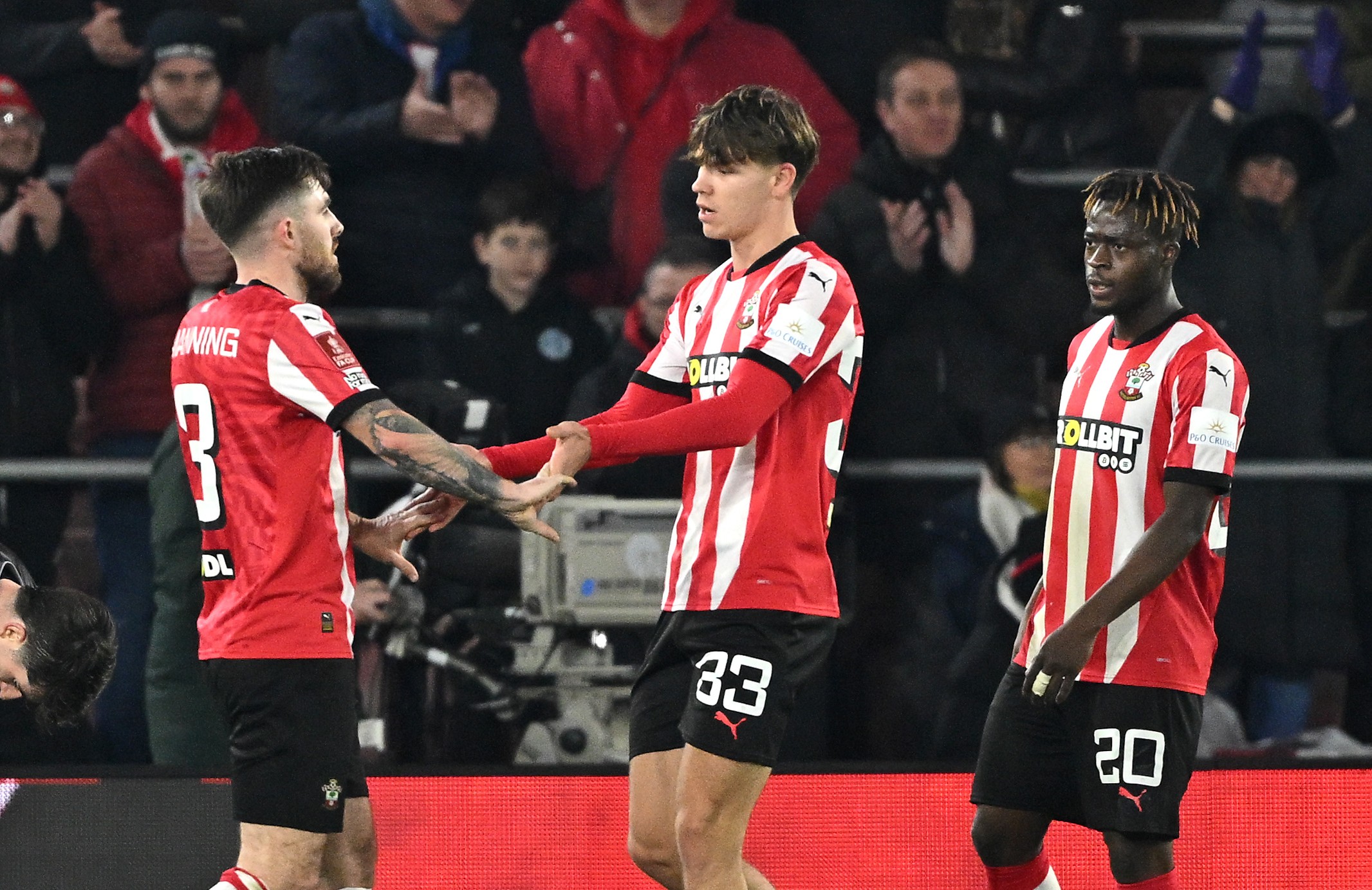 Tyler Dibling of Southampton celebrates scoring his team's third goal with team-mates against Swansea City.