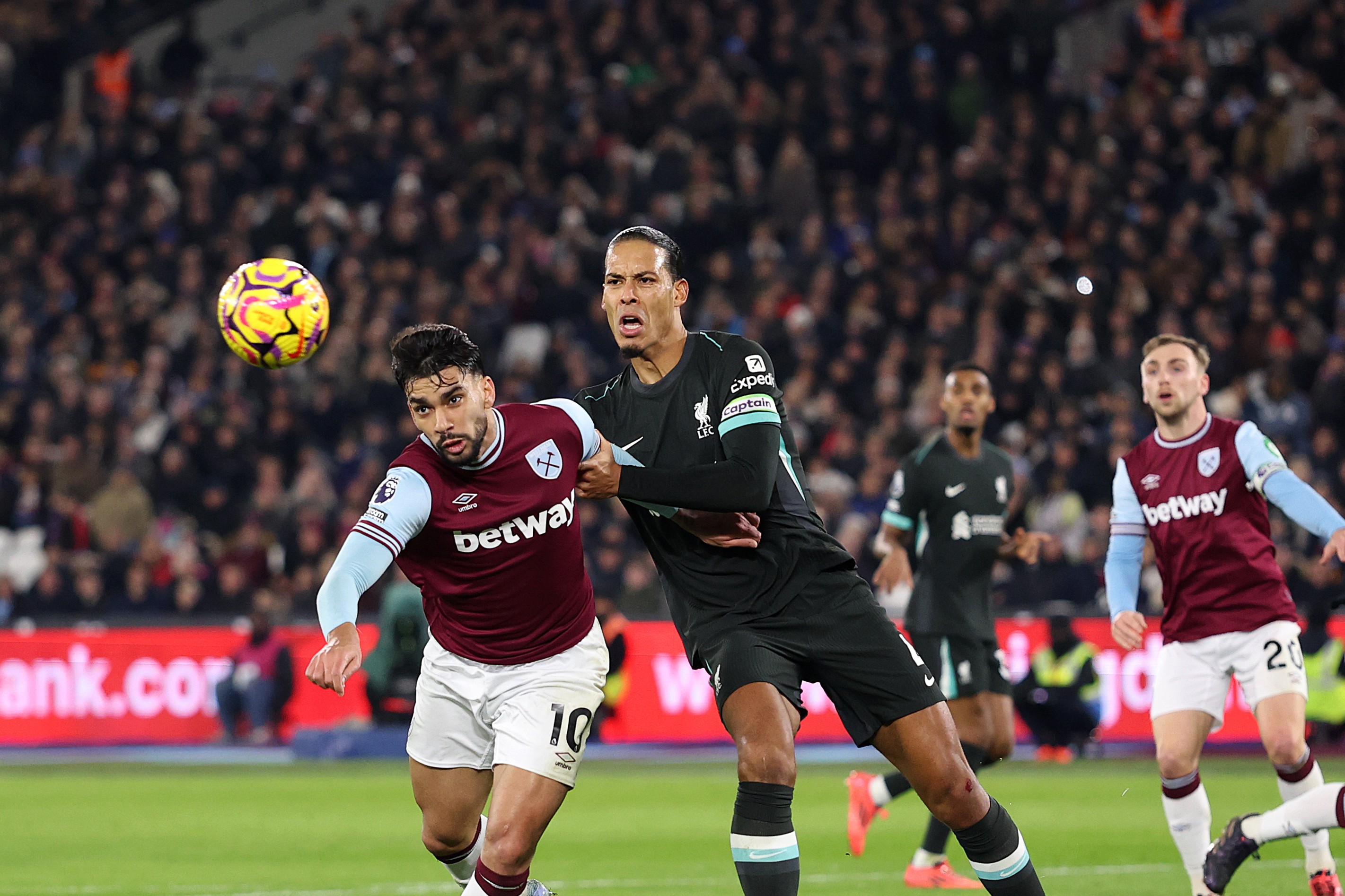 Lucas Paqueta of West Ham United faces Virgil van Dijk of Liverpool