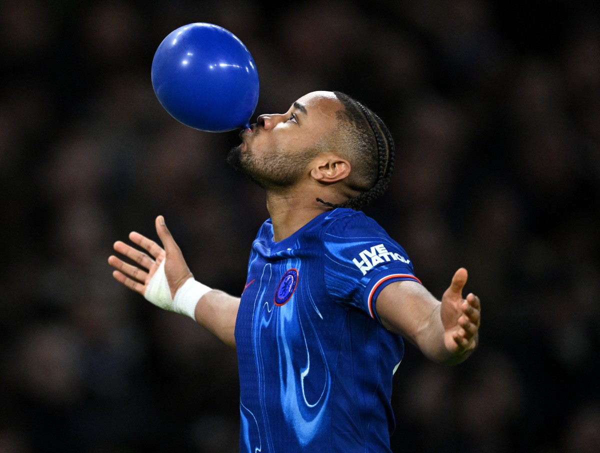 Christopher Nkunku celebrates by blowing a blue balloon after scoring for Chelsea vs Southampton