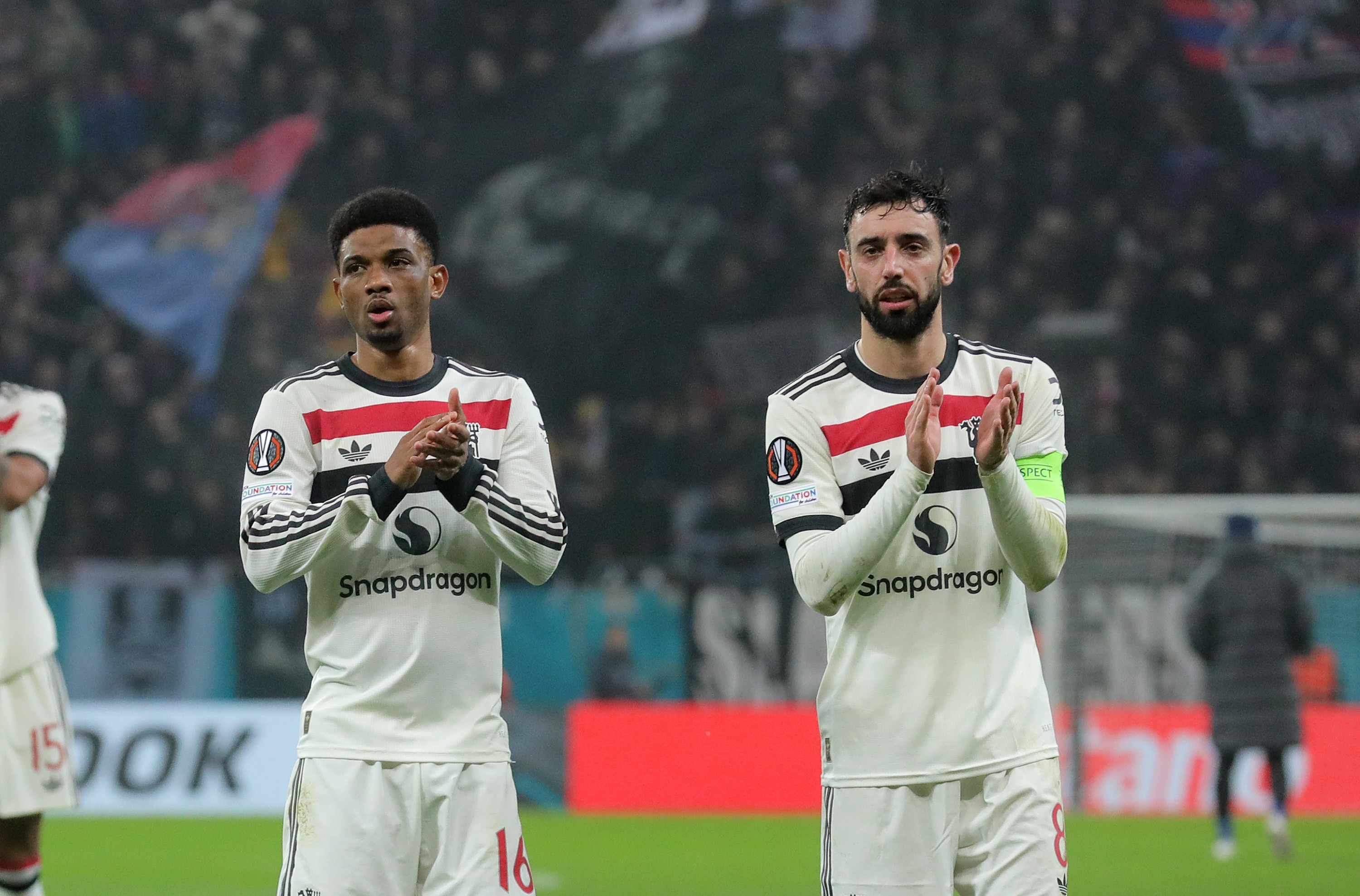 Amad Diallo and Bruno Fernandes of Manchester United applaud the fans