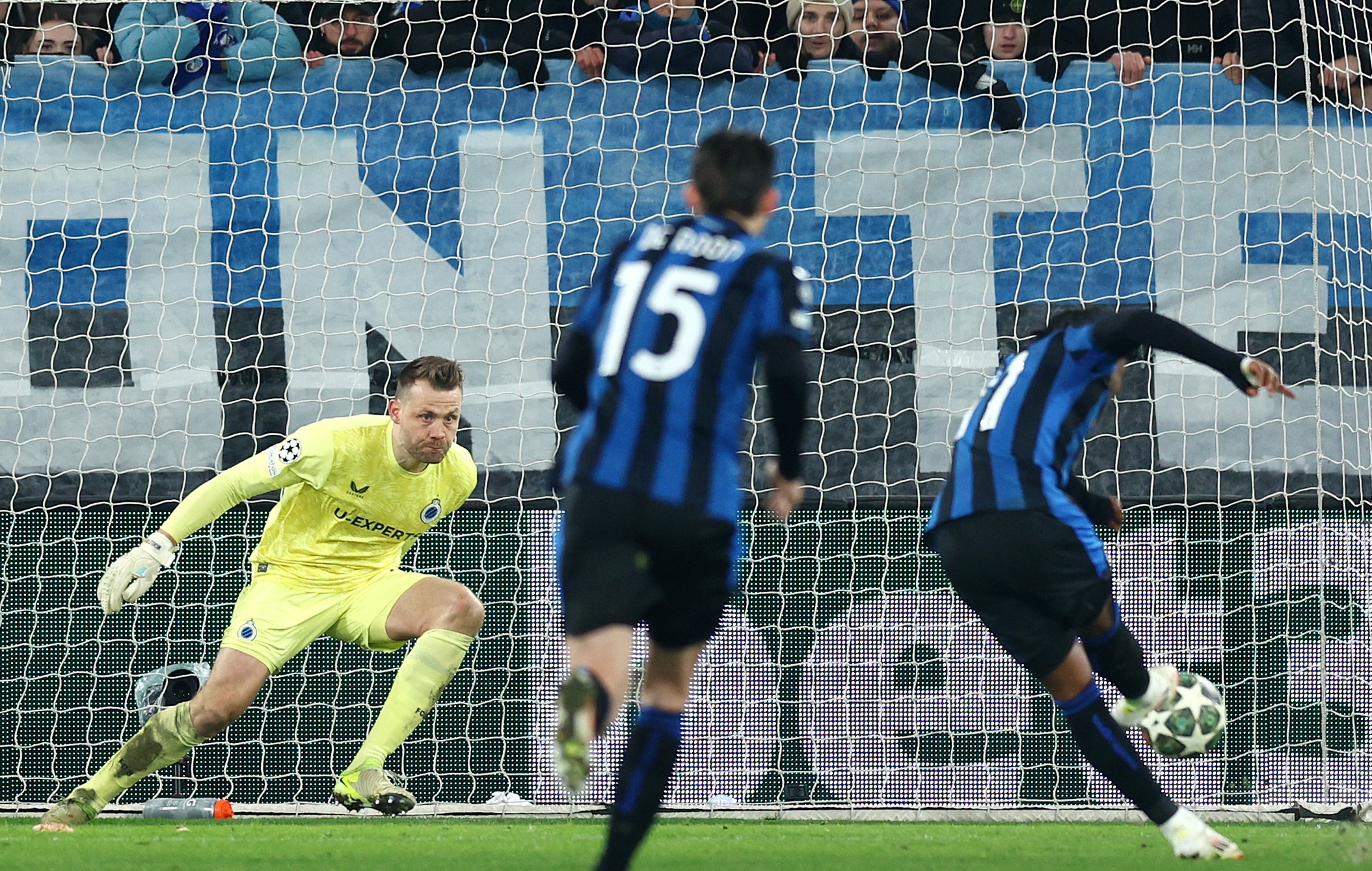 Simon Mignolet of Club Brugge dives as Ademola Lookman of Atalanta shoots and misses from the penalty spot