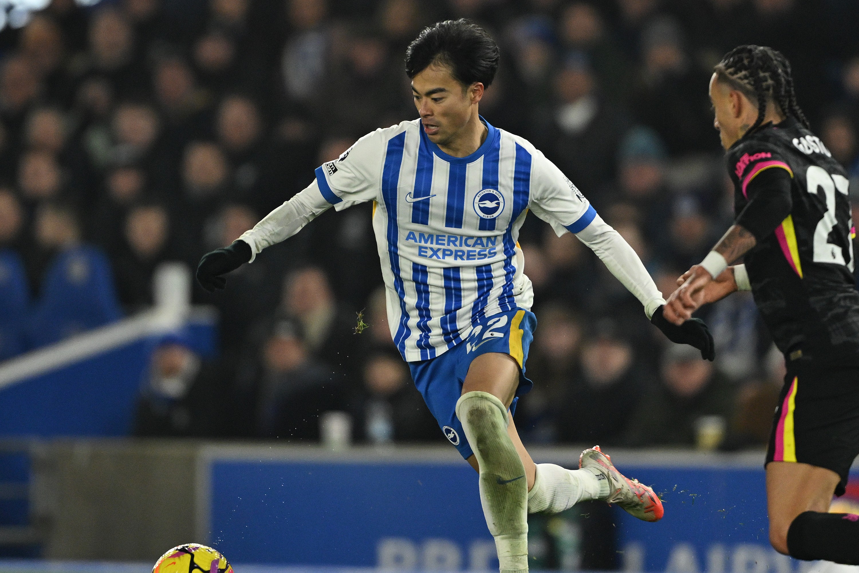 Kaoru Mitoma of Brighton is challenged by Malo Gusto of Chelsea