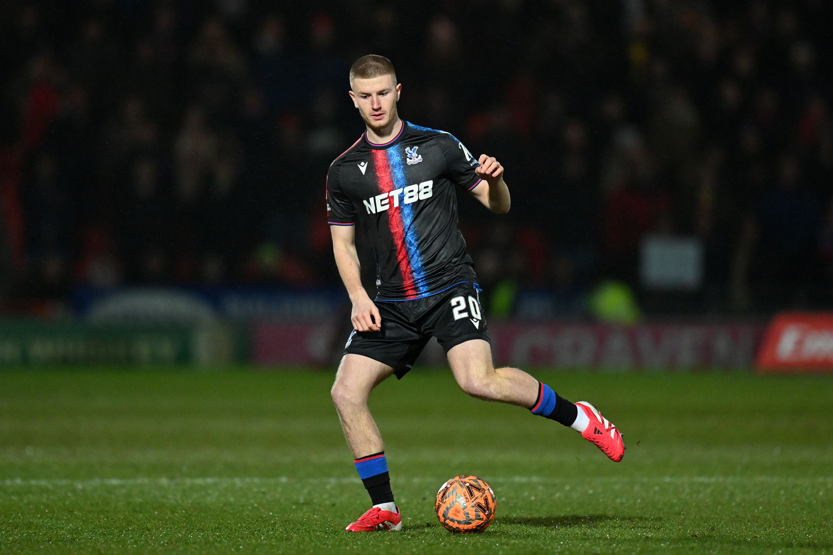 Adam Wharton warms up during a Crystal Palace match