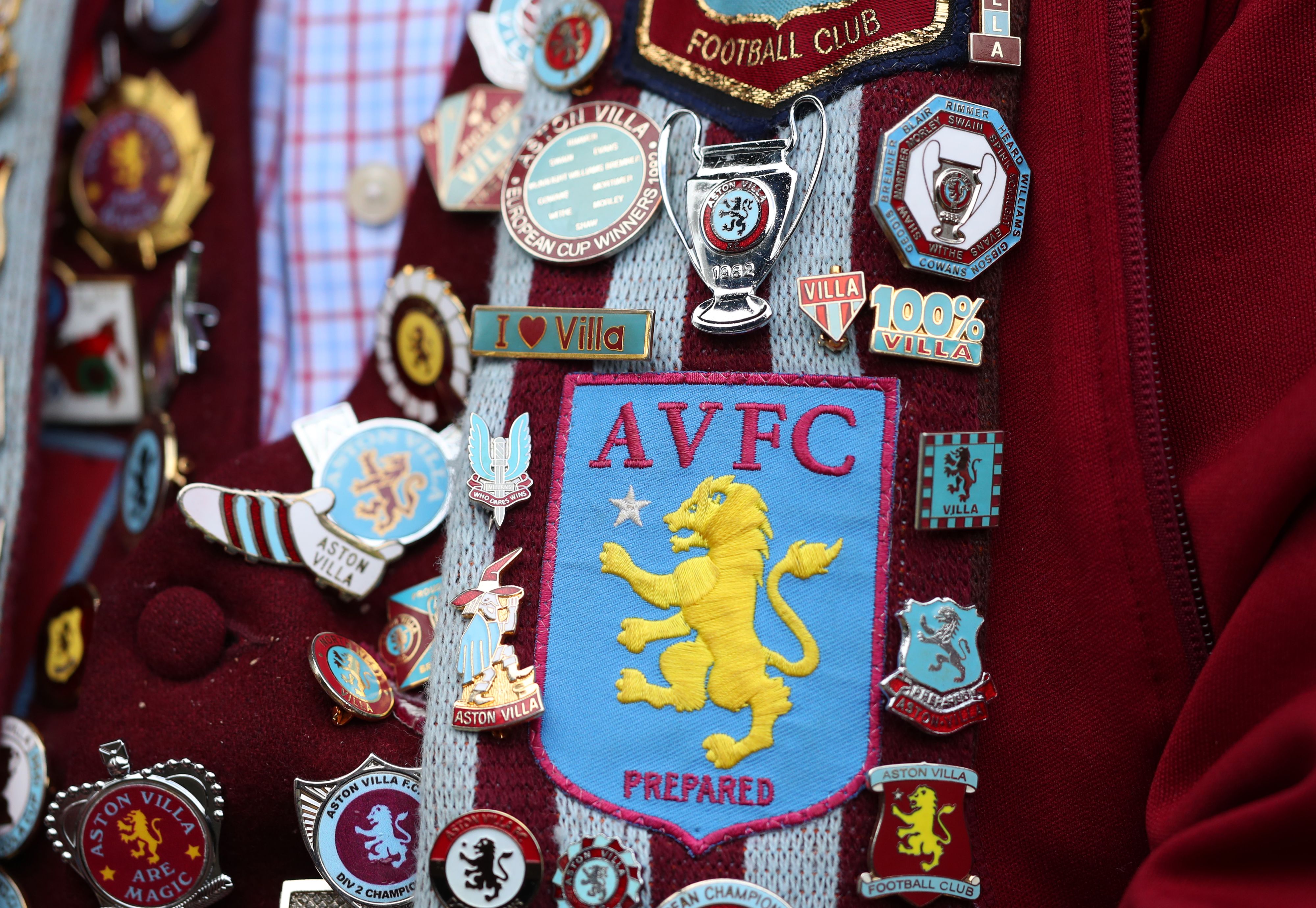 A detailed image of badges on a supporter of Aston Villa