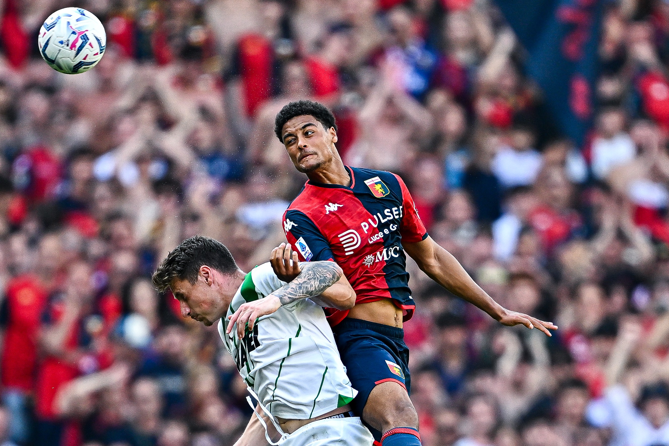 Andrea Pinamonti of Sassuolo and Koni De Winter of Genoa vie for the ball during the Serie A TIM match.