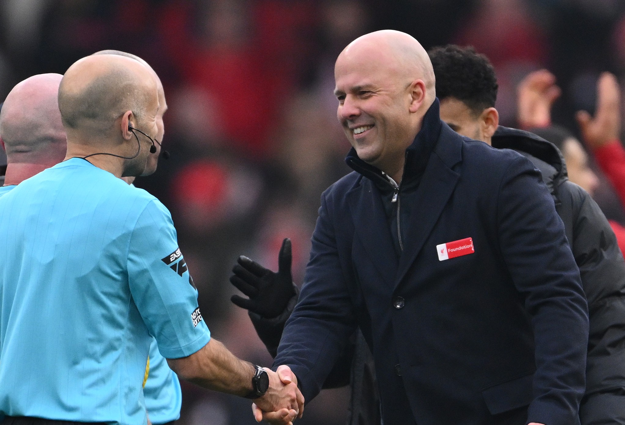 Arne Slot, Manger of Liverpool, shakes hands with the Match Officials 