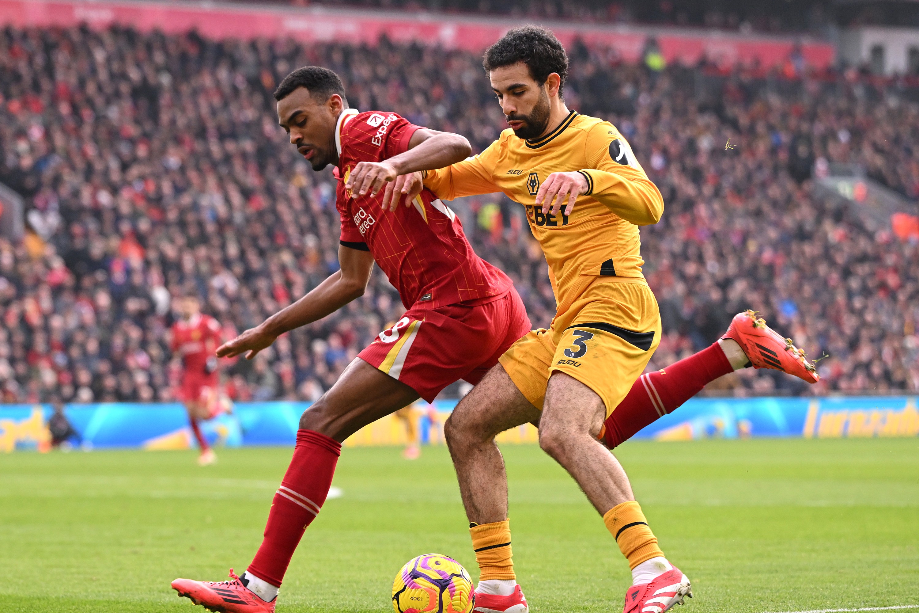 Rayan Ait-Nouri of Wolverhampton Wanderers runs with the ball whilst under pressure from Ryan Gravenberch of Liverpool