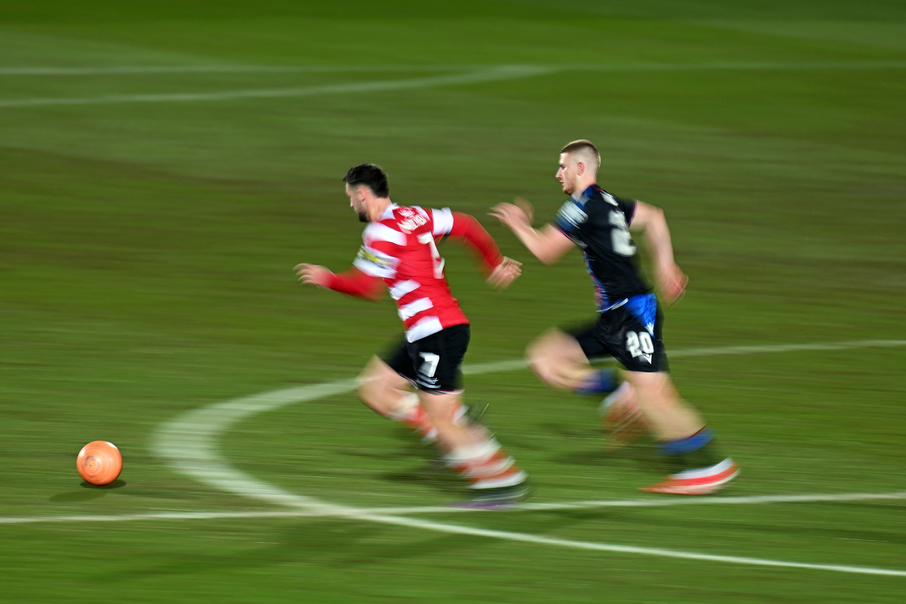 Luke Molyneux of Doncaster Rovers runs for the ball being chased down by Adam Wharton of Crystal Palace during the Emirates FA Cup Fourth Round match