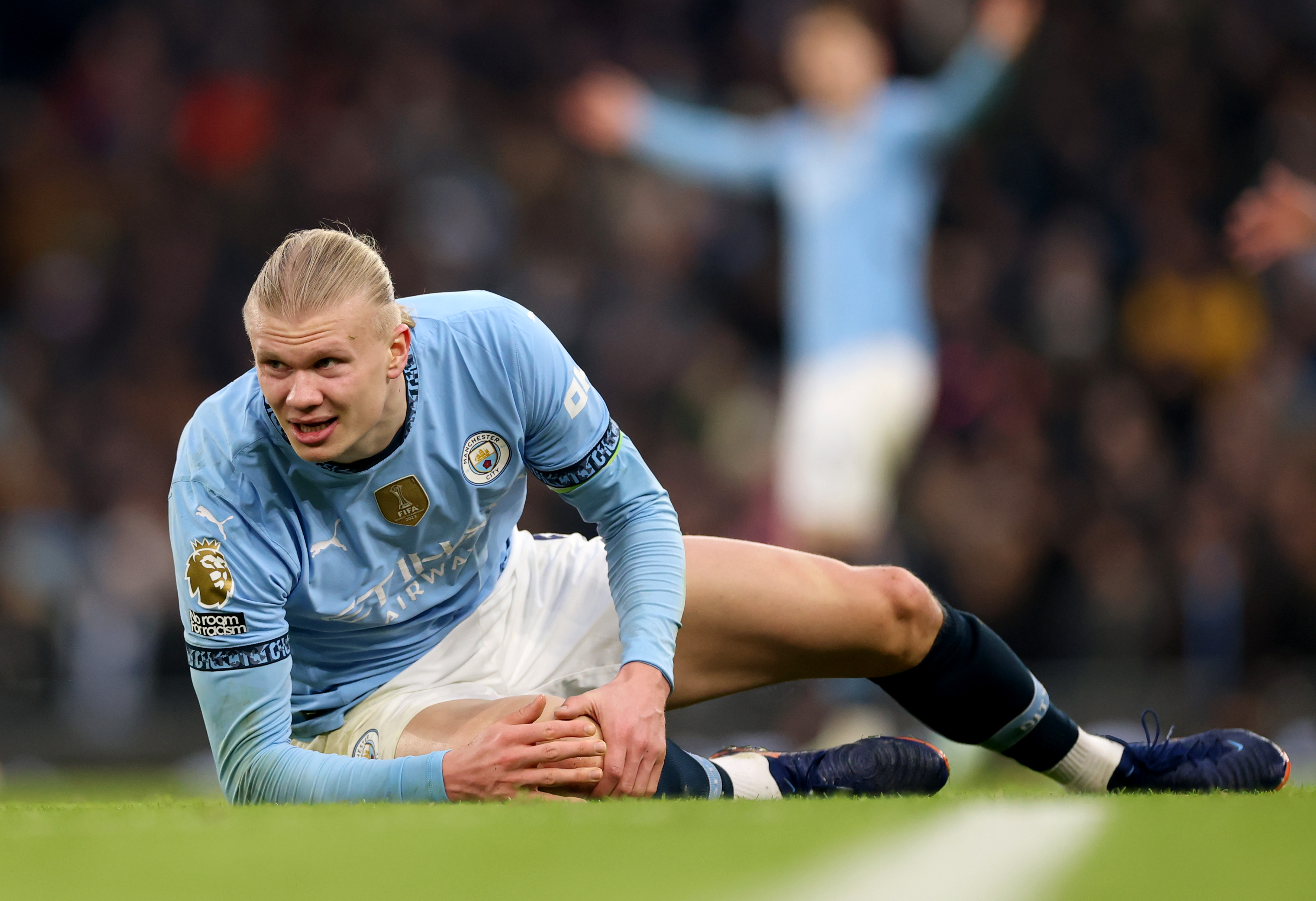 Erling Haaland of Manchester City reacts, while holding his knee