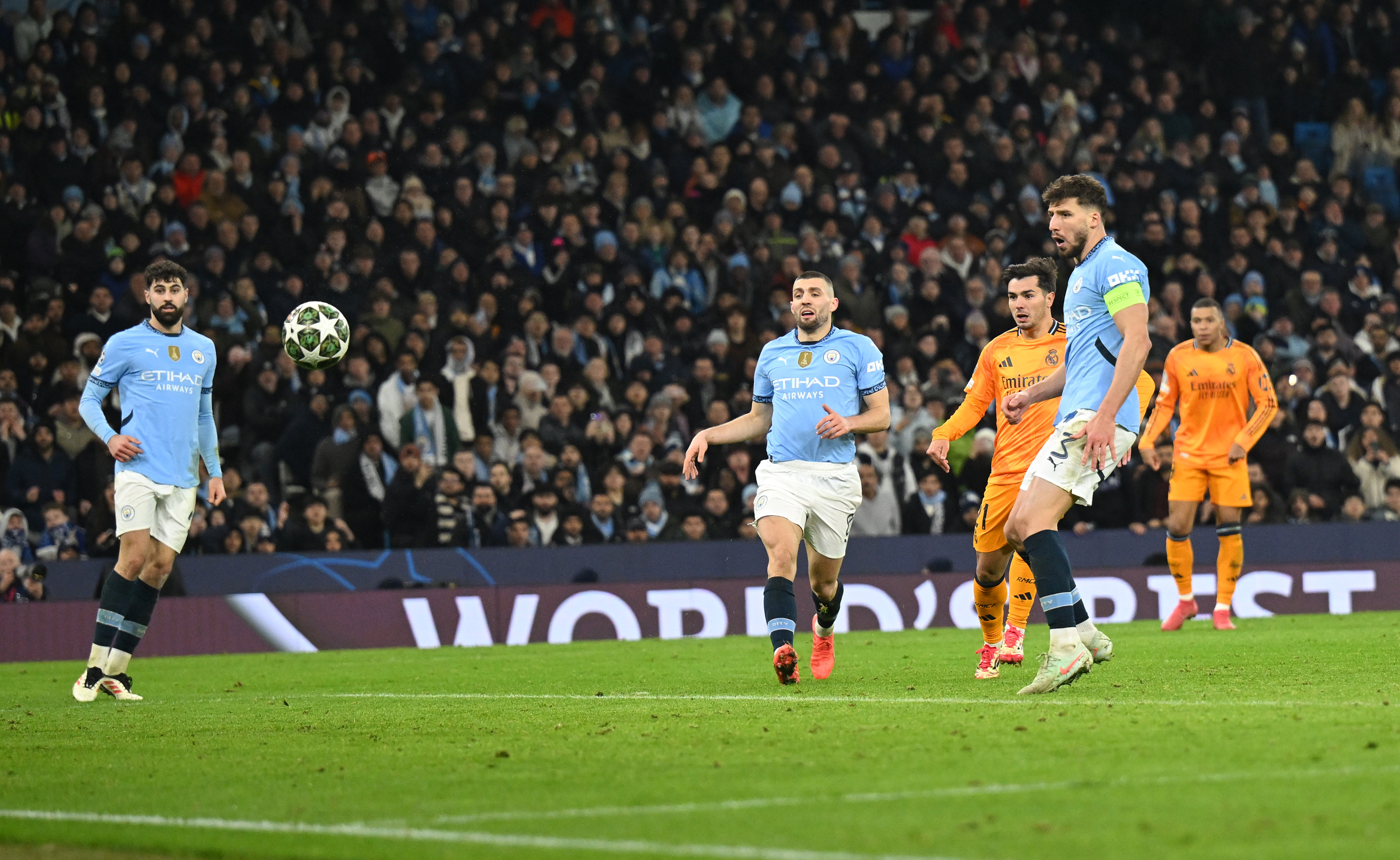 Brahim Diaz of Real Madrid scores his team's second goal whilst under pressure from Mateo Kovacic and Ruben Dias of Manchester City during the UEFA Champions League Knockout Play-off first leg match