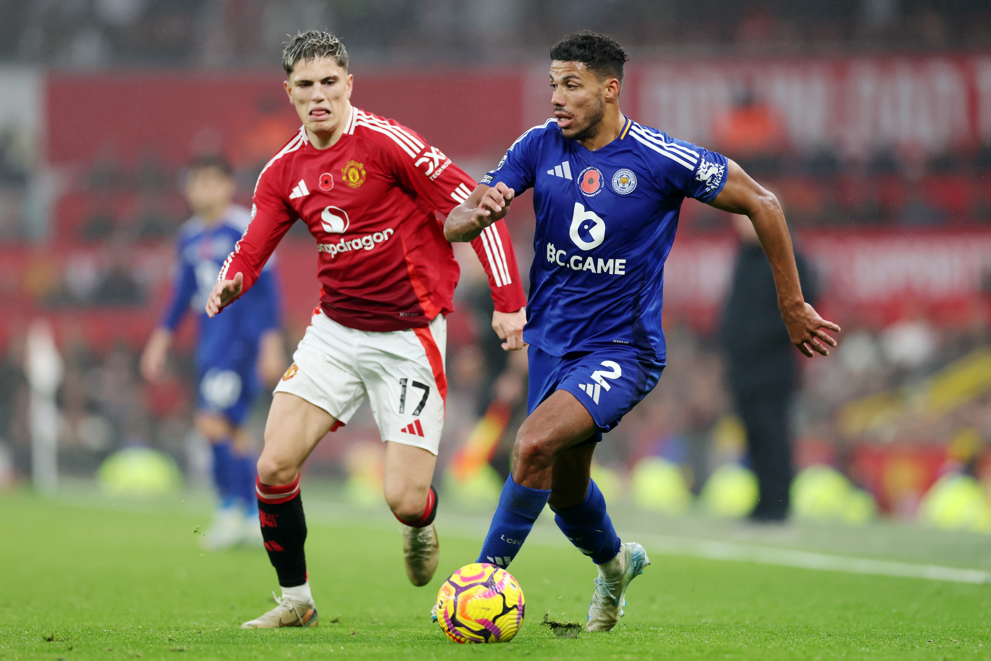 James Justin of Leicester City runs with the ball whilst under pressure from Alejandro Garnacho