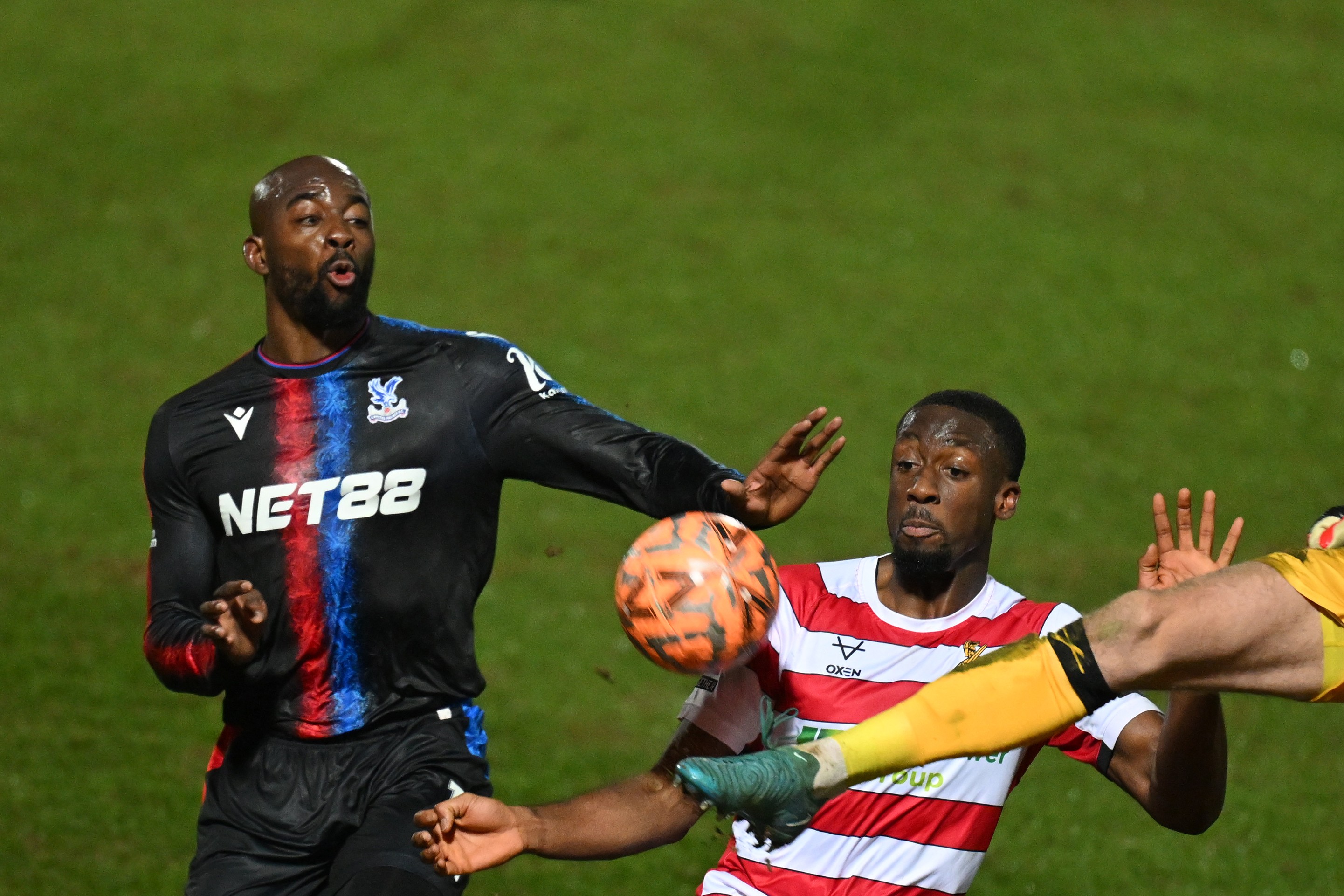 Jean-Philippe Mateta, by Crystal Palace, struggle with the ball with Joseph Olowu by Doncaster Rovers