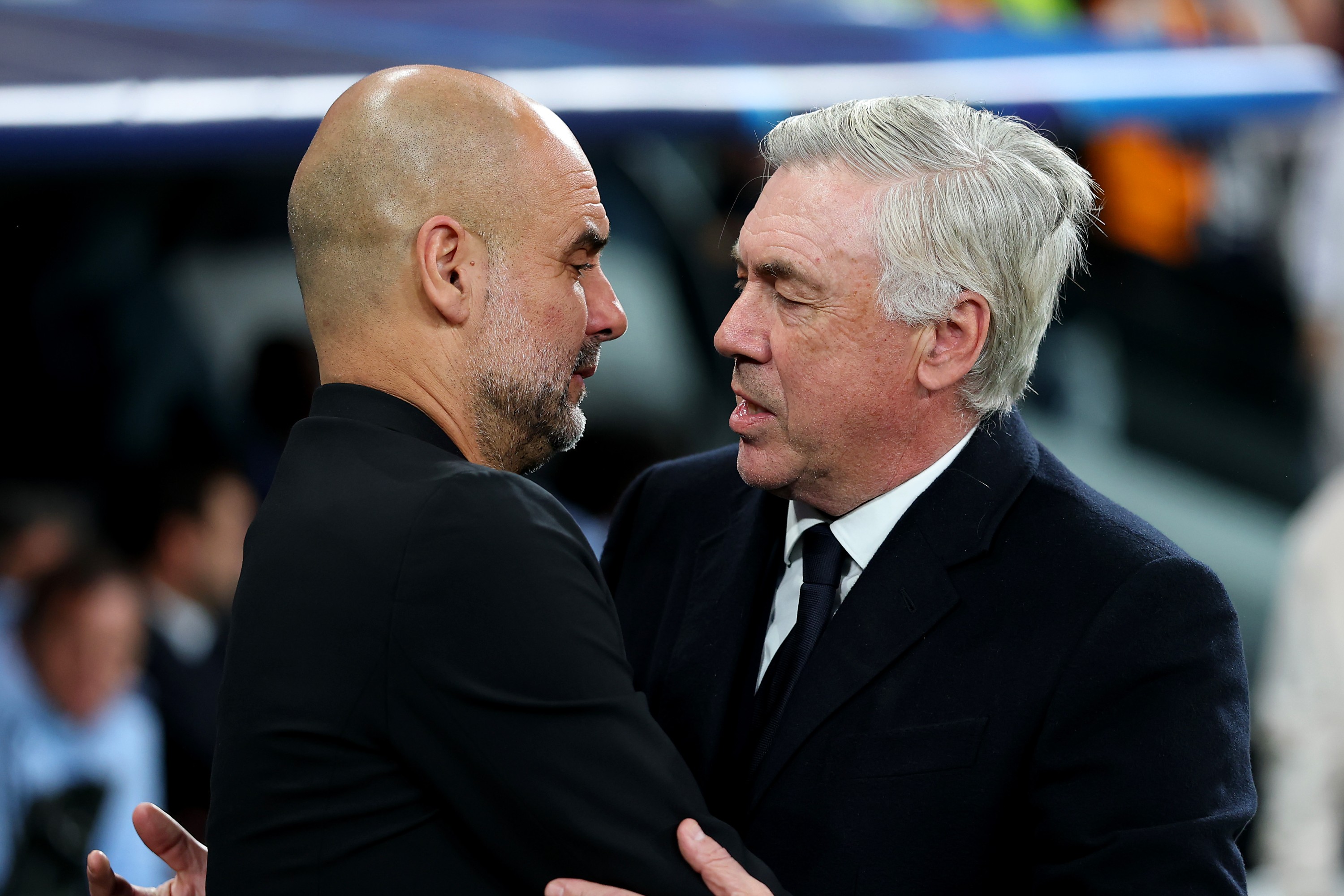 Pep Guardiola, Manager of Manchester City, embraces Carlo Ancelotti, Head Coach of Real Madrid