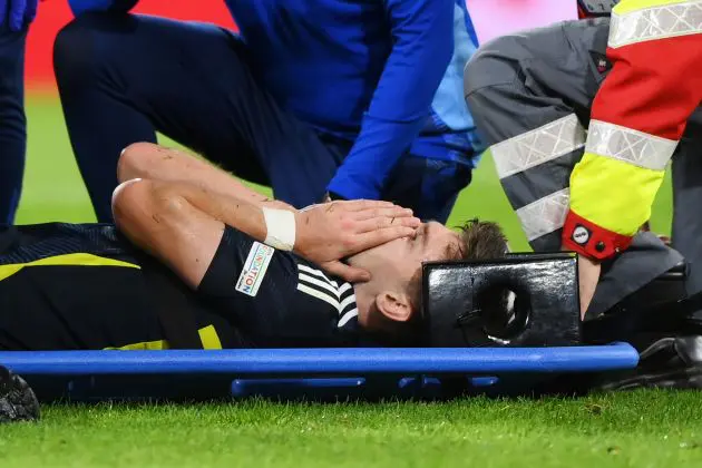 Kieran Tierney of Scotland reacts as he is stretchered off