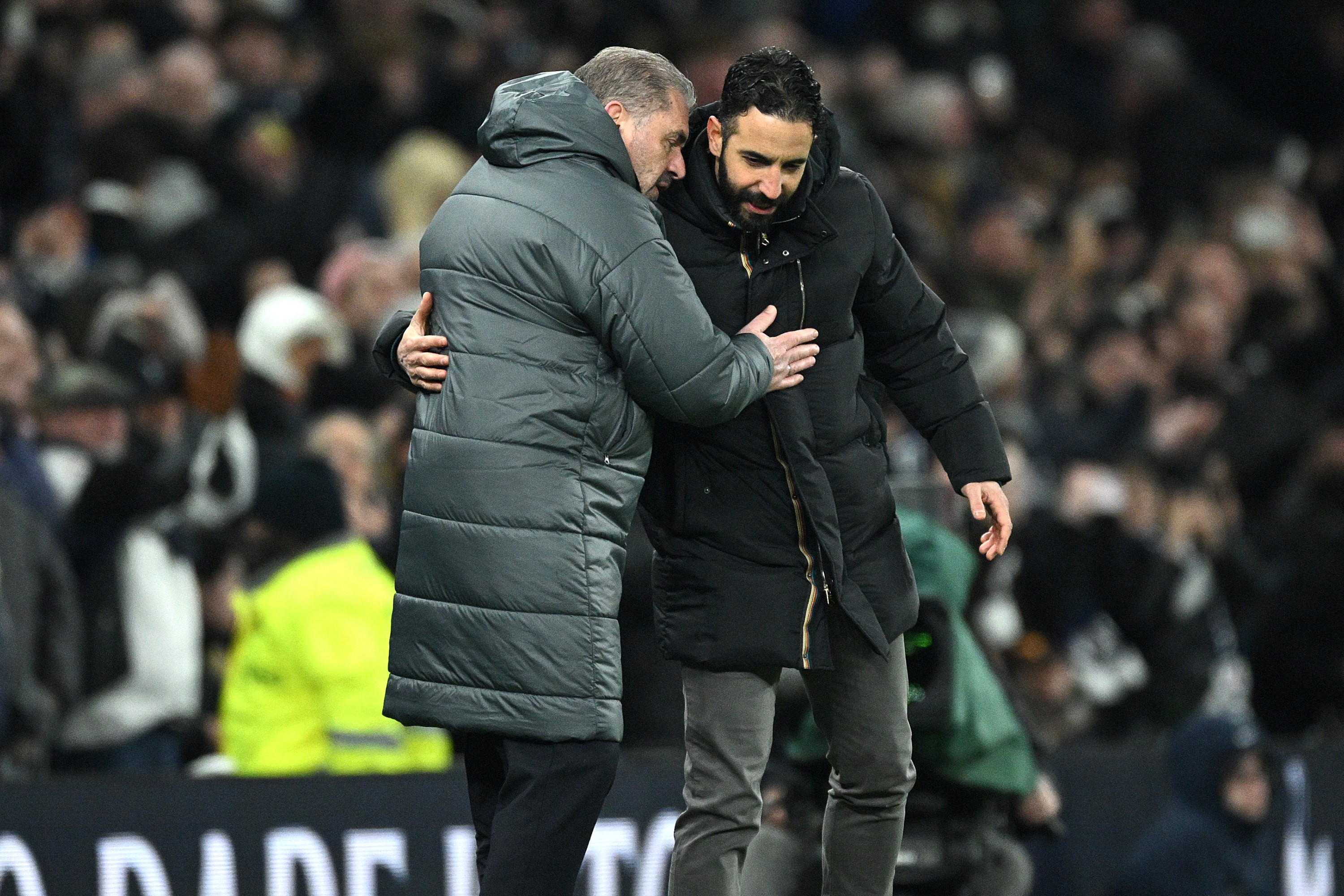 Ange Postecoglou, Manager of Tottenham Hotspur, and Ruben Amorim, Manager of Manchester United, embrace