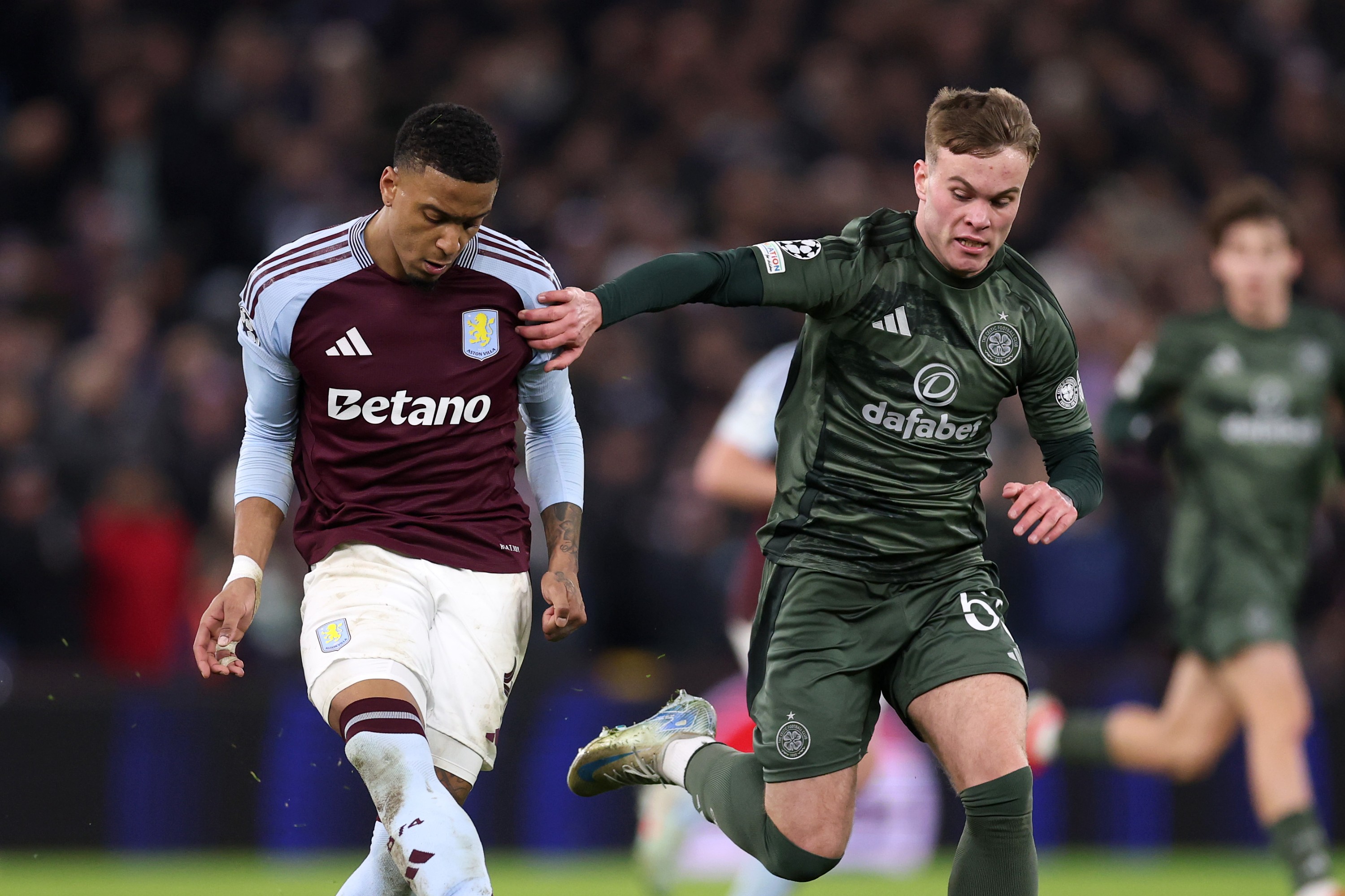 Ezri Konsa of Aston Villa passes the ball from Daniel Cummings of Celtic