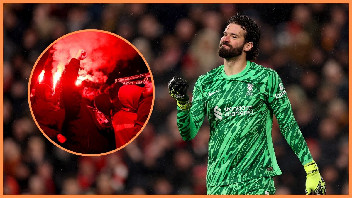 Alisson Becker holds up his fist next to PSG fans with flares.