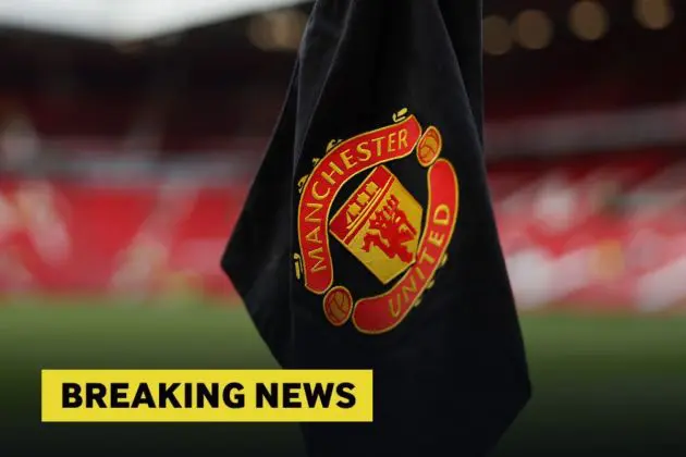 Manchester United corner flag at Old Trafford with yellow breaking news banner