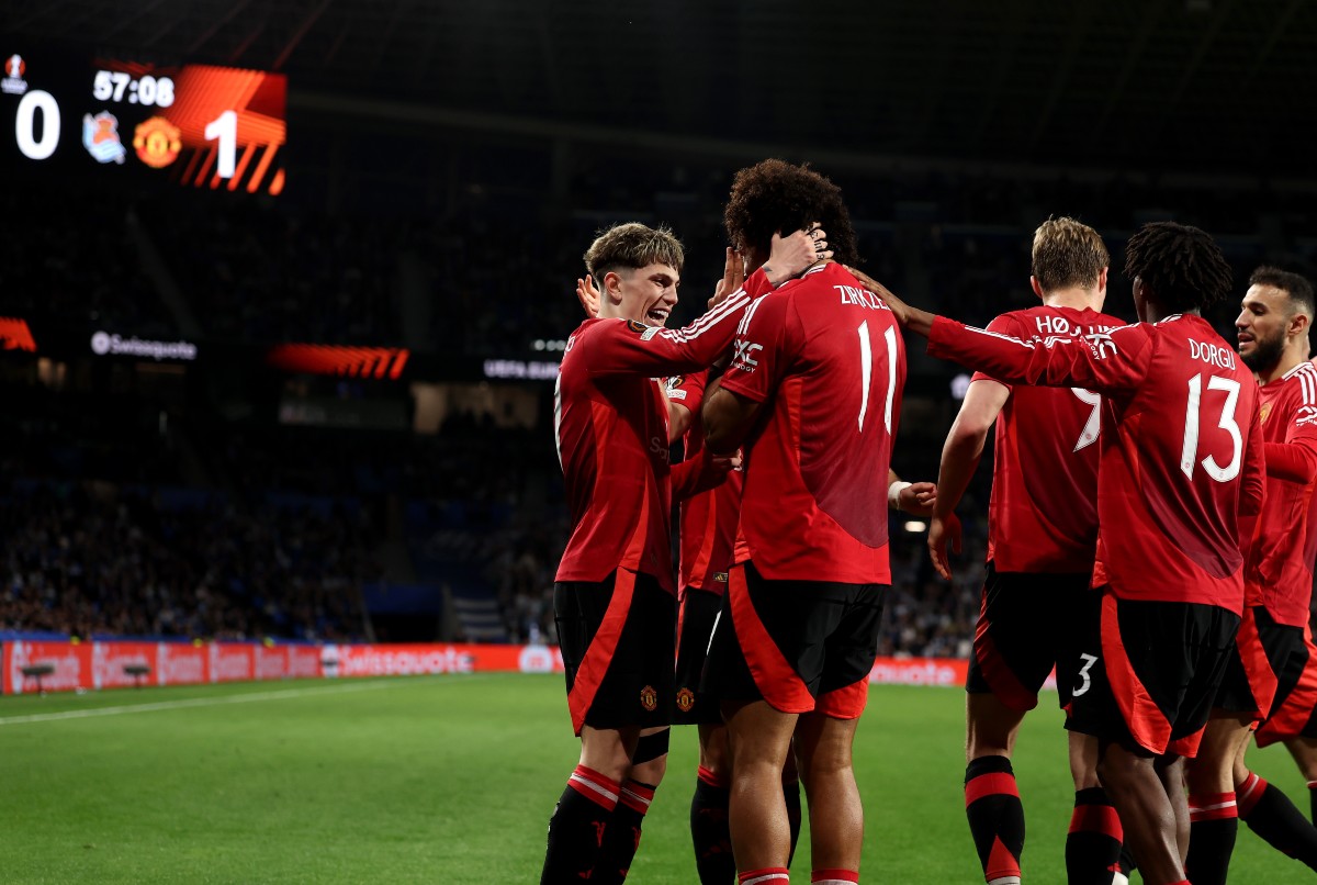 Man United players celebrate after scoring against Real Sociedad