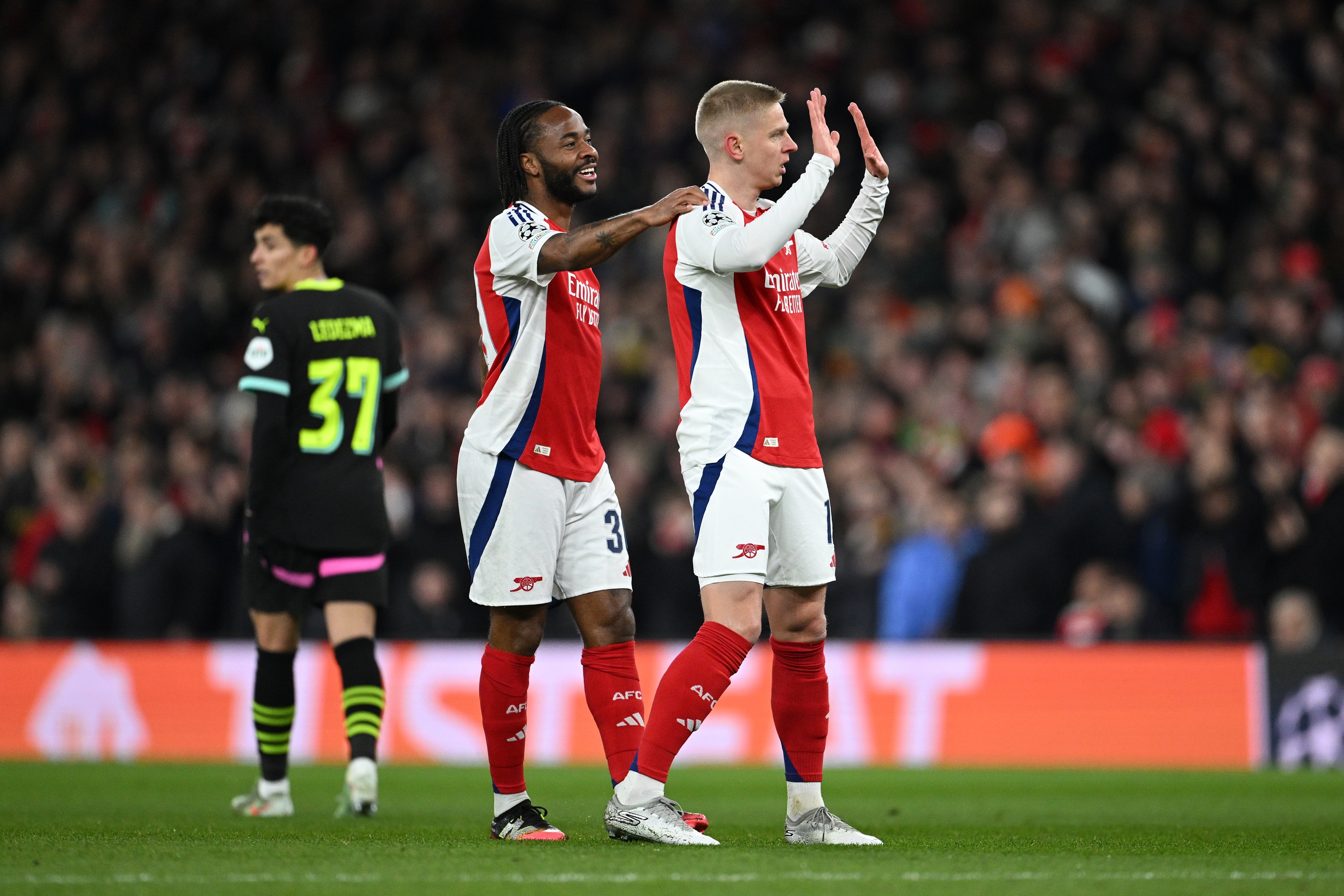 Raheem Sterling touches Oleksandr Zinchenko's shoulder during Arsenal vs PSV.