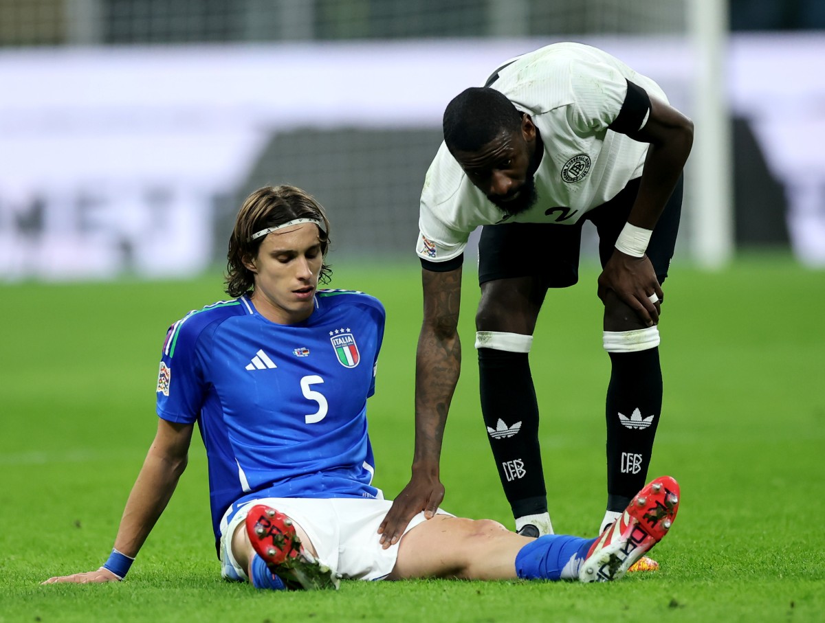 Riccardo Calafiori is comforted by Antonio Rudiger