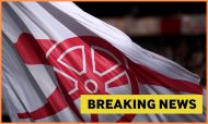 Arsenal flag at the Emirates Stadium with yellow 'breaking news' banner