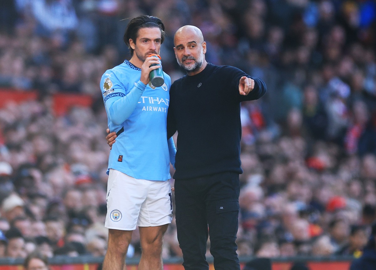 Pep Guardiola gives instructions to Jack Grealish