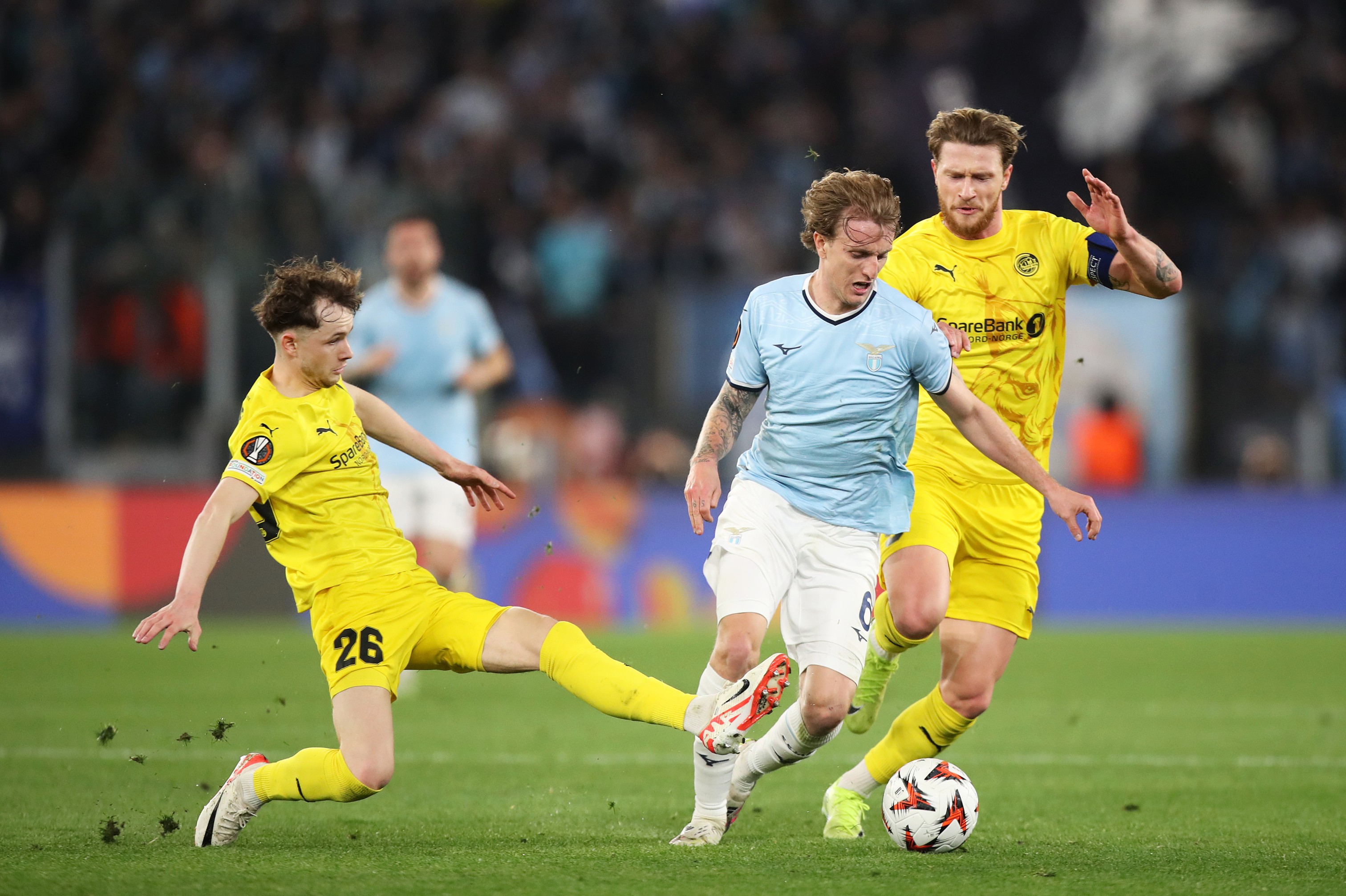 Nicolo Rovella of Lazio is challenged by Hakon Evjen and Kasper Hoegh