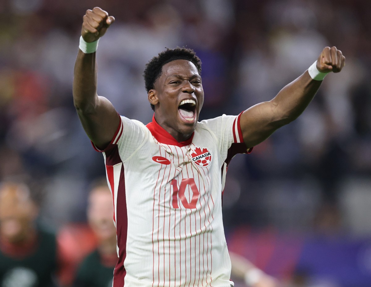 Jonathan David celebrates a win with the Canadian national team