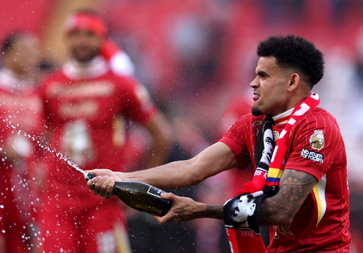 Luis Diaz celebrates with champagne after Liverpool's Premier League title victory