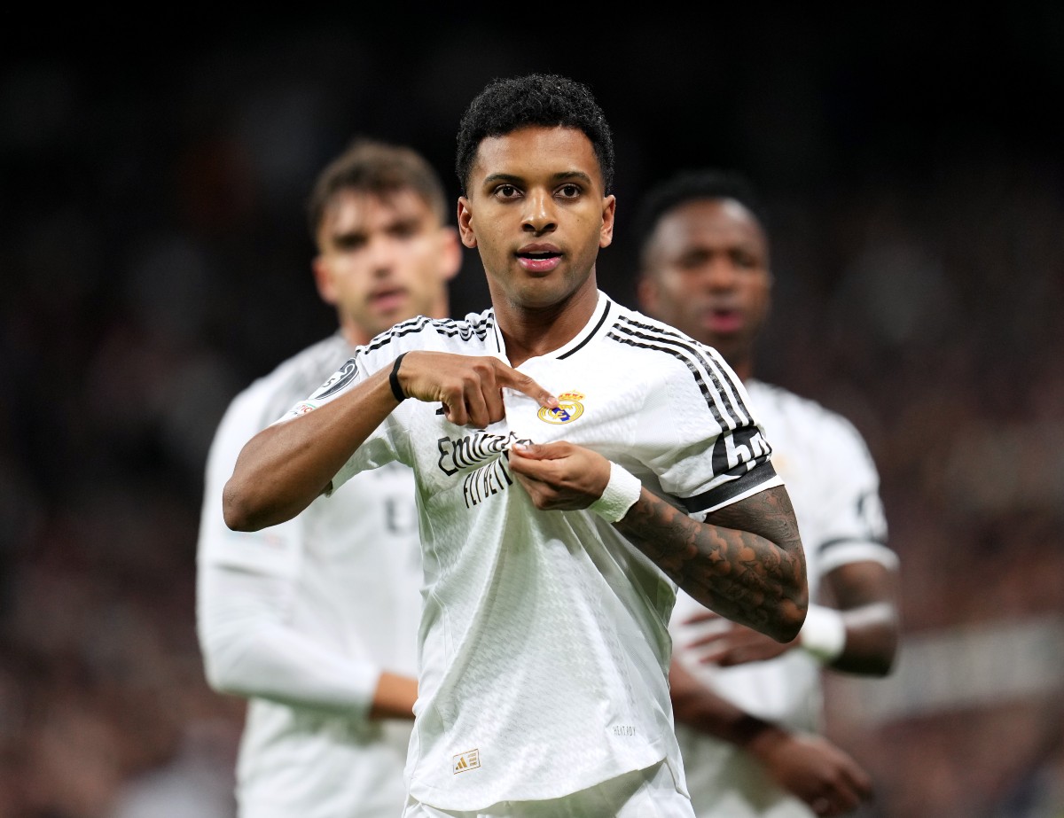 Rodrygo Goes points to the Real Madrid badge in celebration