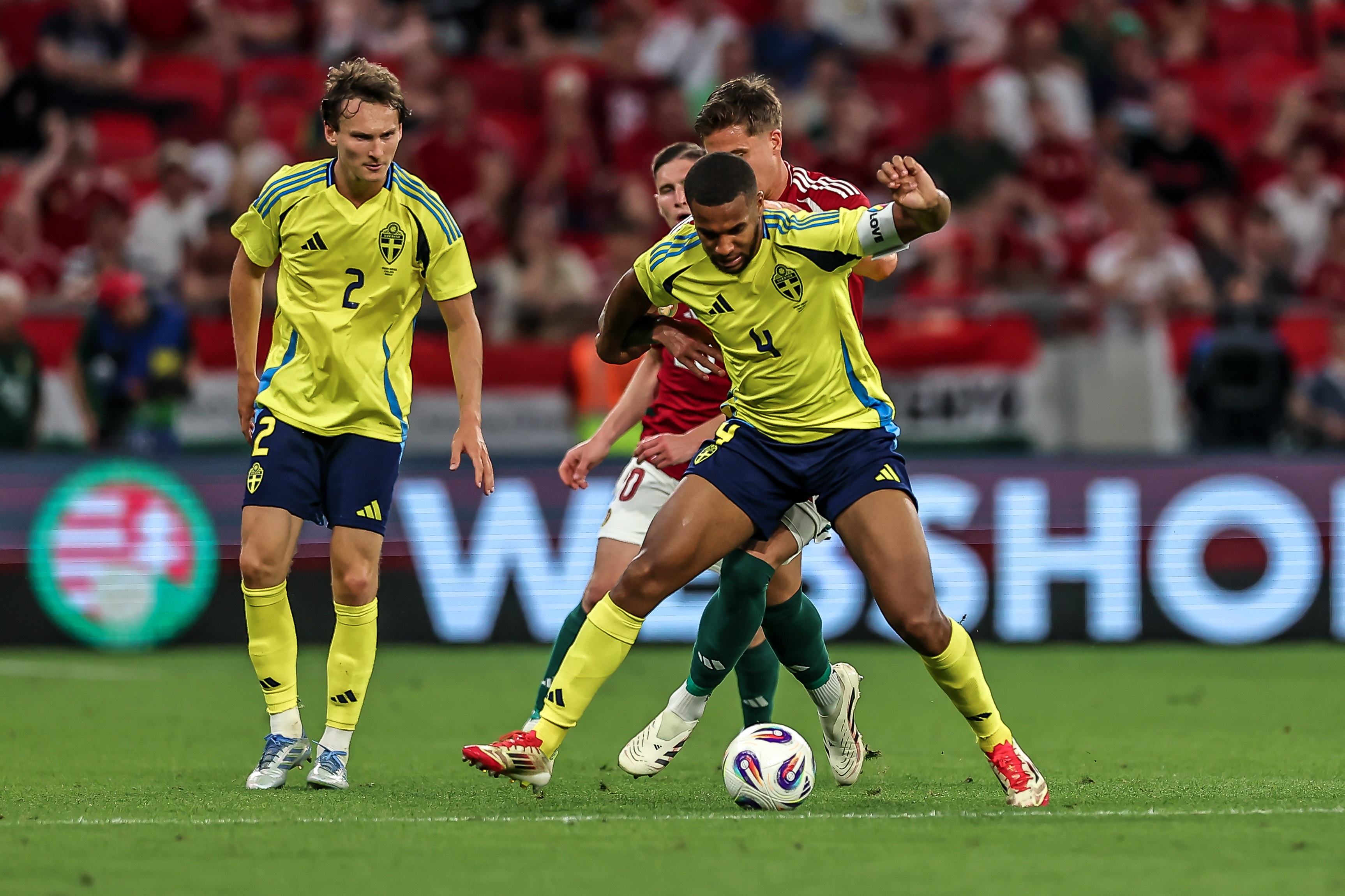 Alexander Isak holds off an opponent from the ball.
