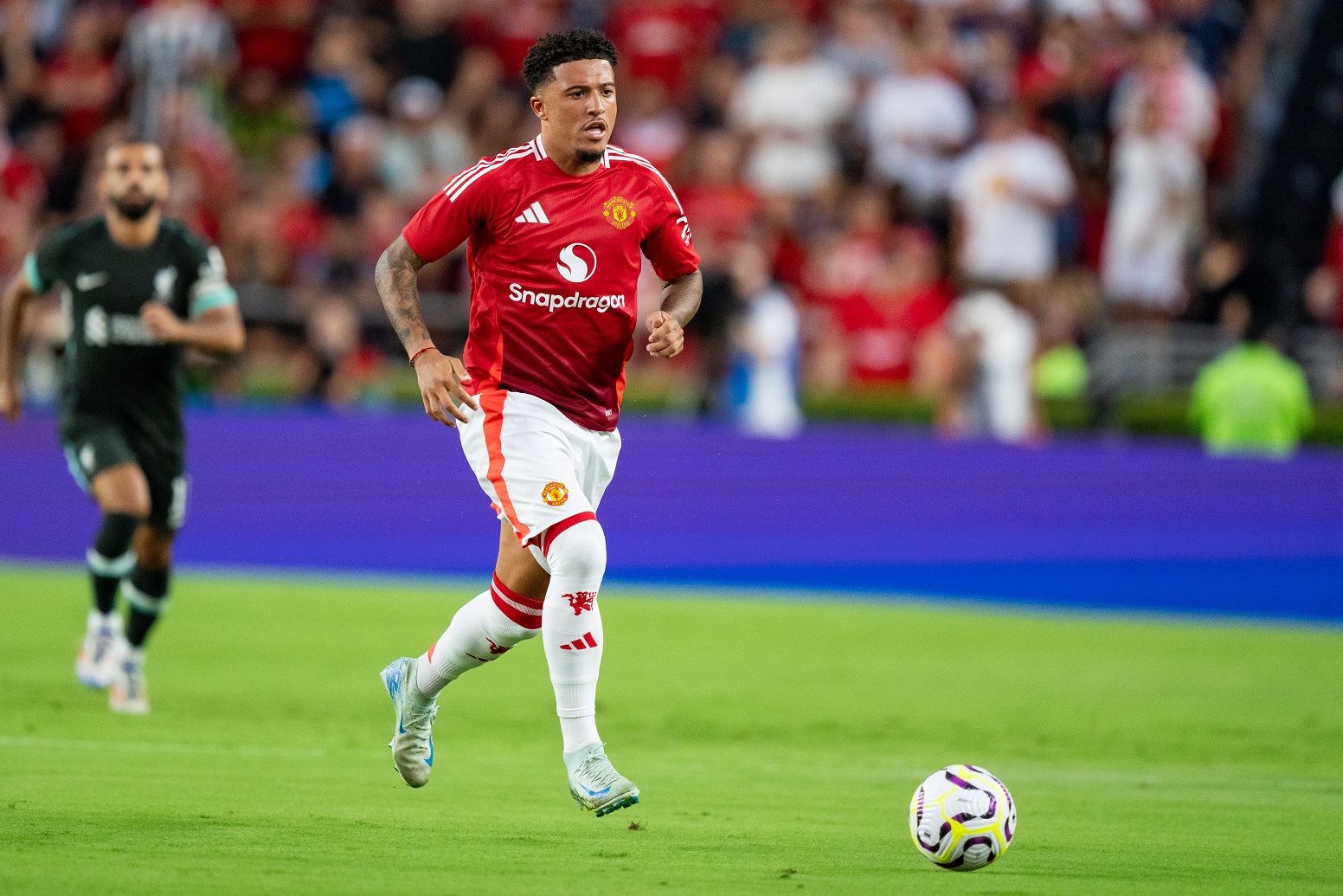 Jadon Sancho runs with the ball