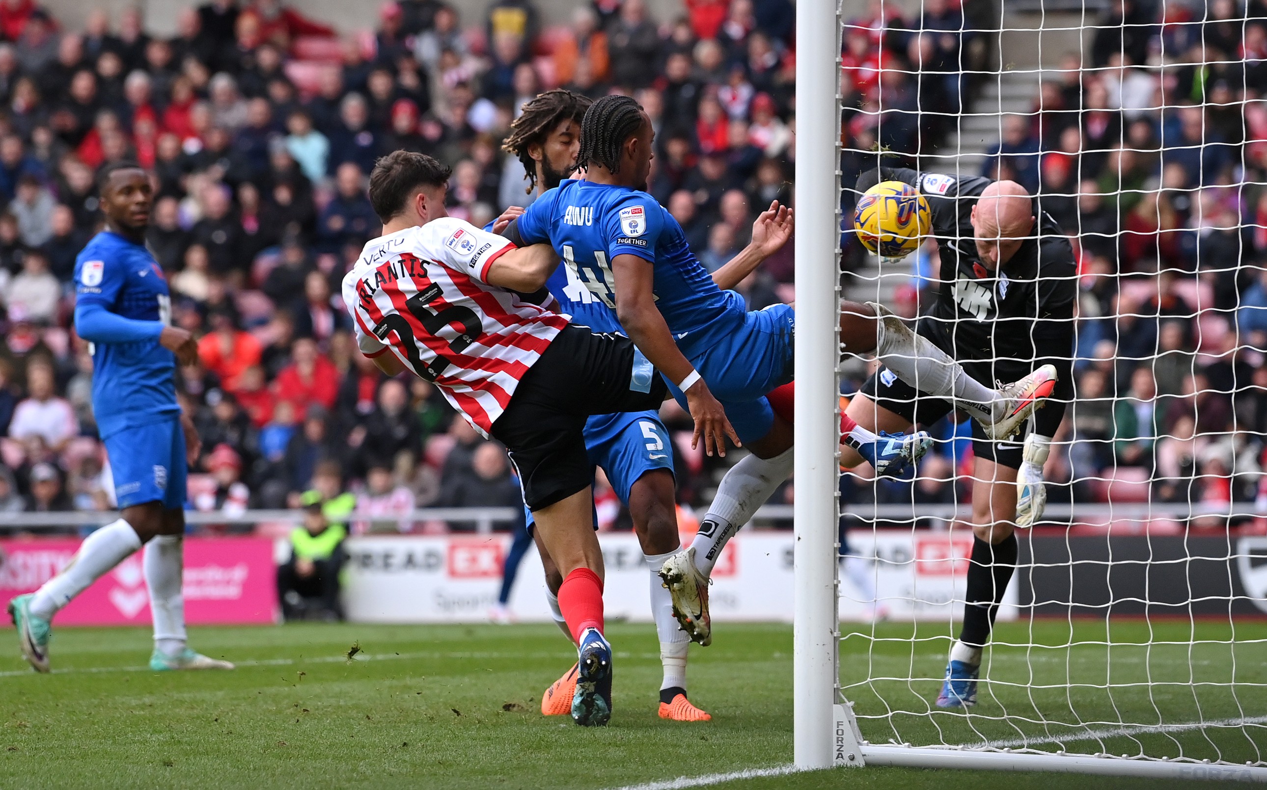 Sunderland player Nectar Triantis (l) beats Birmingham defender Emanuel Aiwu to score