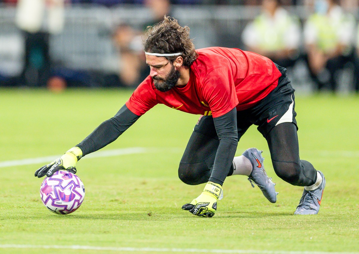 Alisson warms up for Liverpool