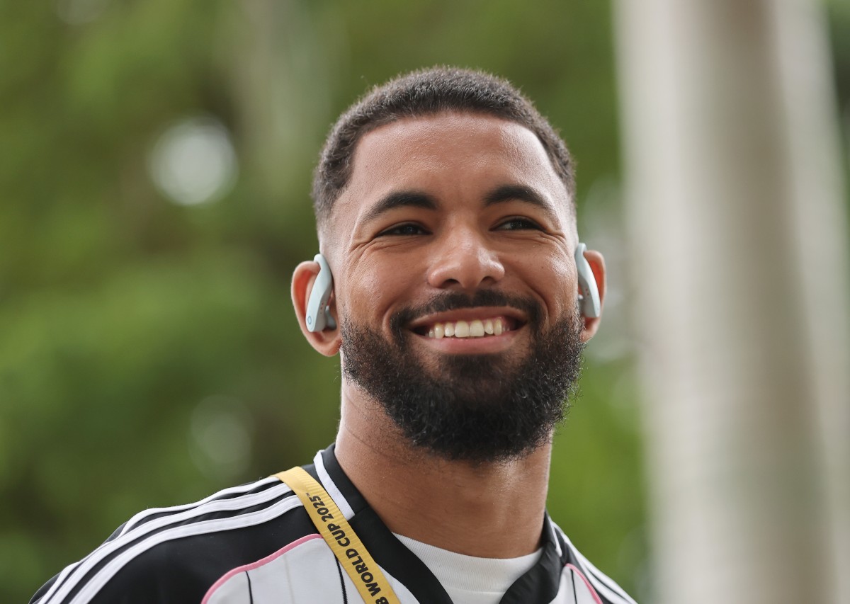 Douglas Luiz smiles as he arrives with the Juventus squad at the Club World Cup